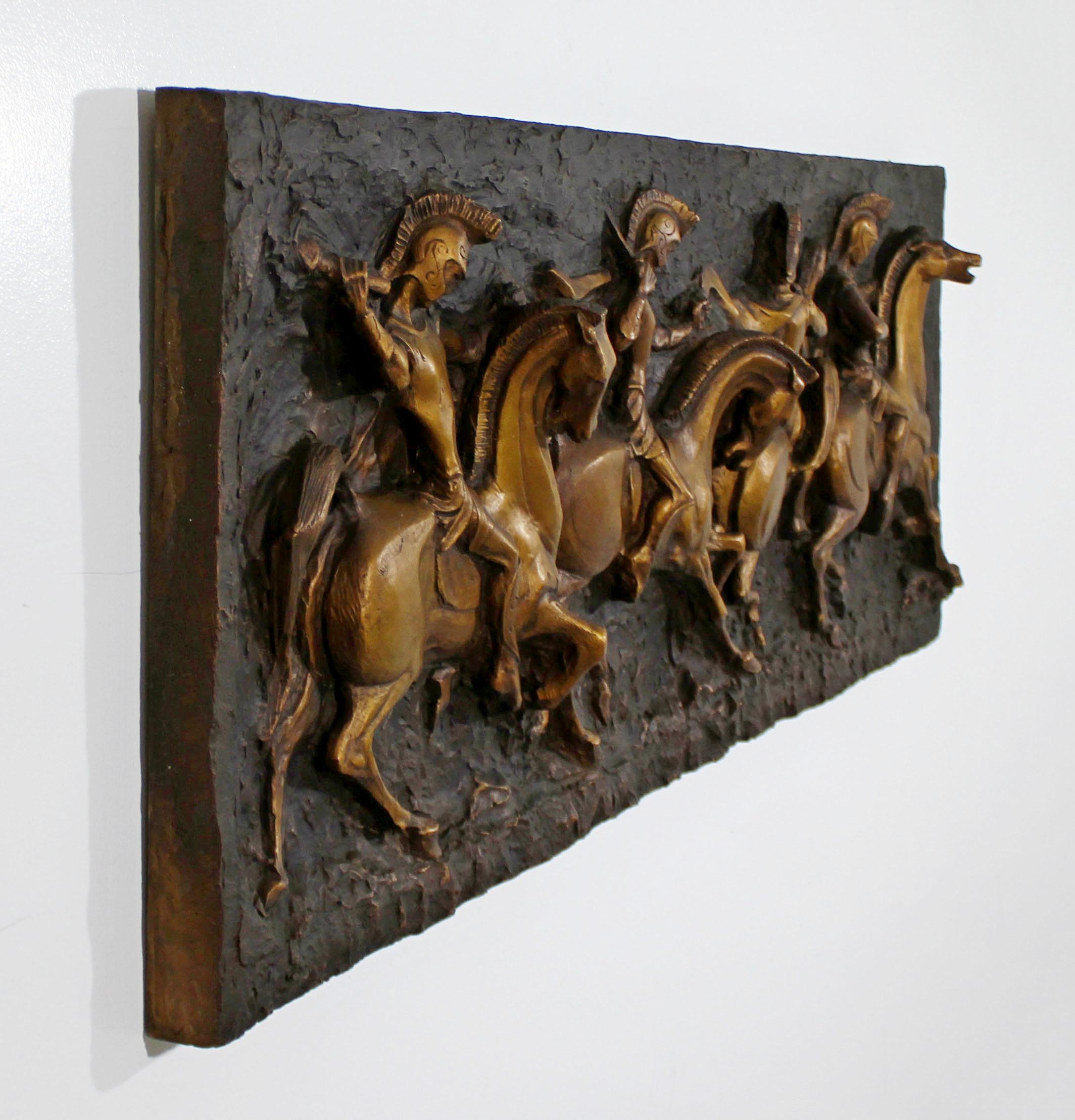 For your consideration is a phenomenal, brass finish fiberglass wall relief sculpture, depicting Roman soldiers, by Finesse Originals, circa 1960s. In excellent vintage condition. The dimensions are 61.5