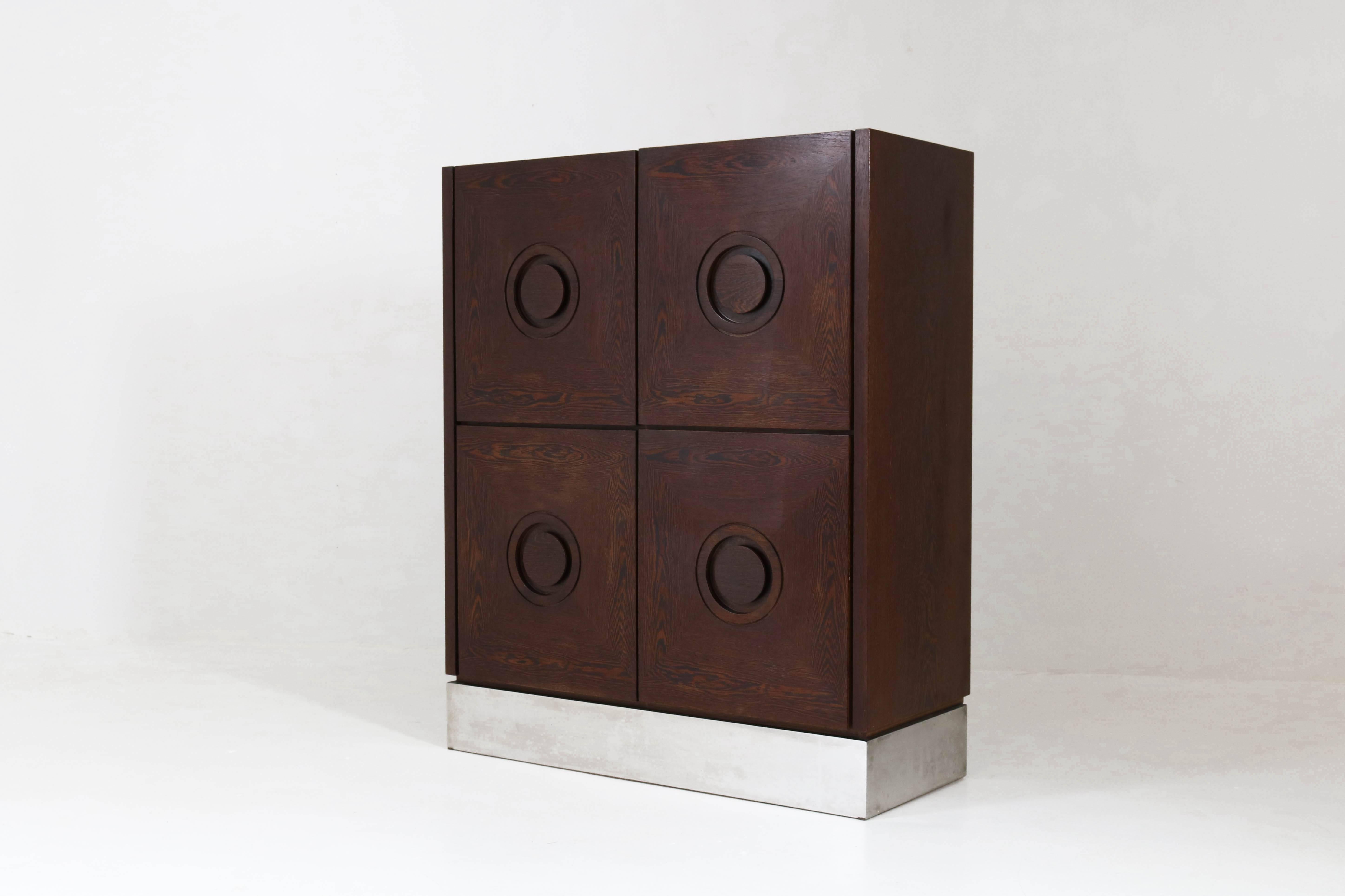 Stunning Mid-Century Modern Brutalist Belgium bar cabinet, 1970s.
Wengé with graphical door panels and metal lining.
This striking piece of furniture was purchased at the famous Amsterdam department store De Bijenkorf
during the 1970s.
In good
