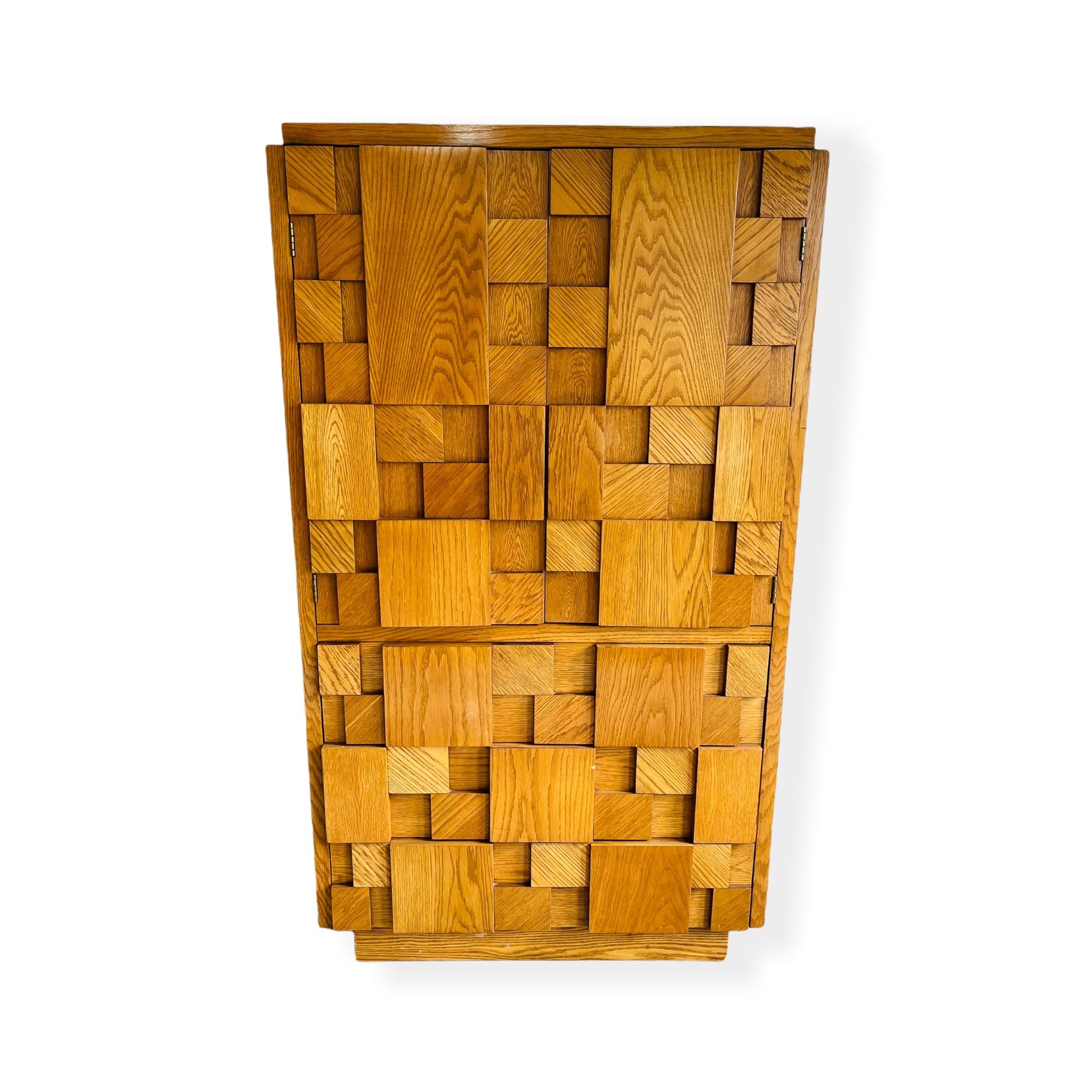 Beautiful sculpted Mid-Century Modern woodblock cabinet by Lane Furniture. This piece is equipped with 3 large drawer below and two door to open up to plenty of storage space and one additional drawer. This piece can be used as a liquor cabinet or