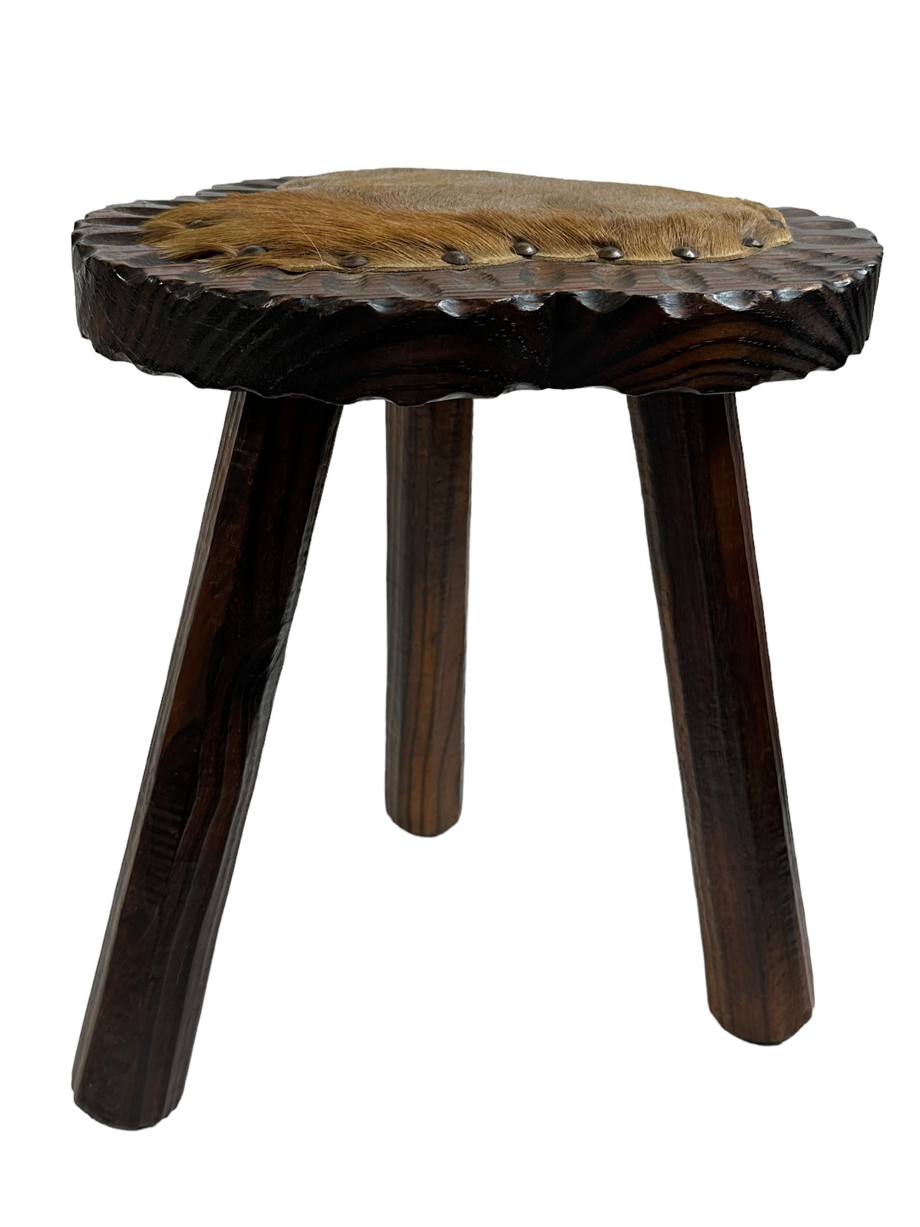 An interesting brutalist stool with hand carved legs and great patina. Great piece of functional sculpture. It is in great vintage condition and is structurally sound. Nice addition to your room, entry hall or patio. Found at an Estate Sale in