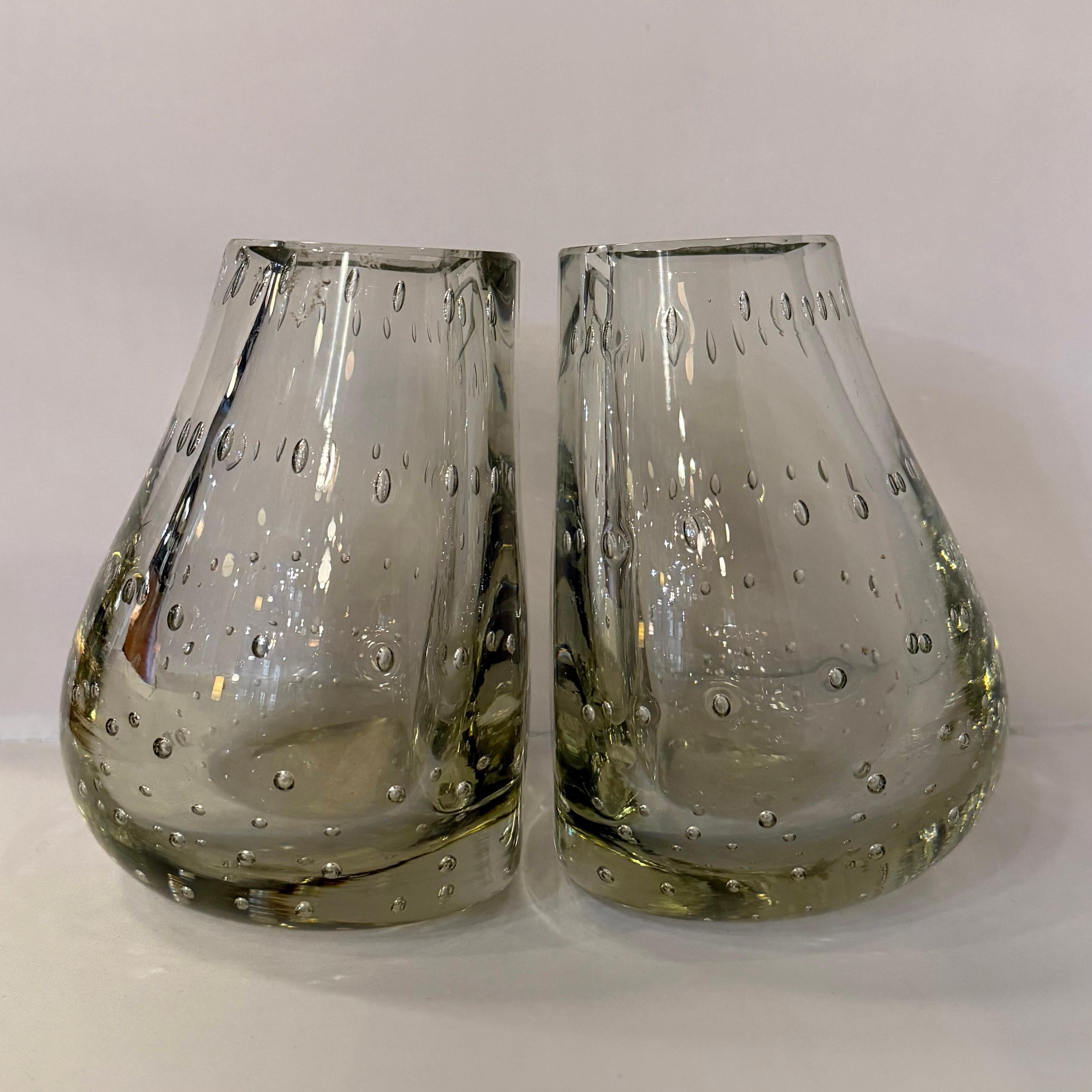 This wonderfully unique pair of mid-century modern glass vases double as bookends for a fantastic accent in any room. The bookend vases were designed by Swedish American master glass-blower Carl Erikson for Erikson Glass Works. The thick smoke