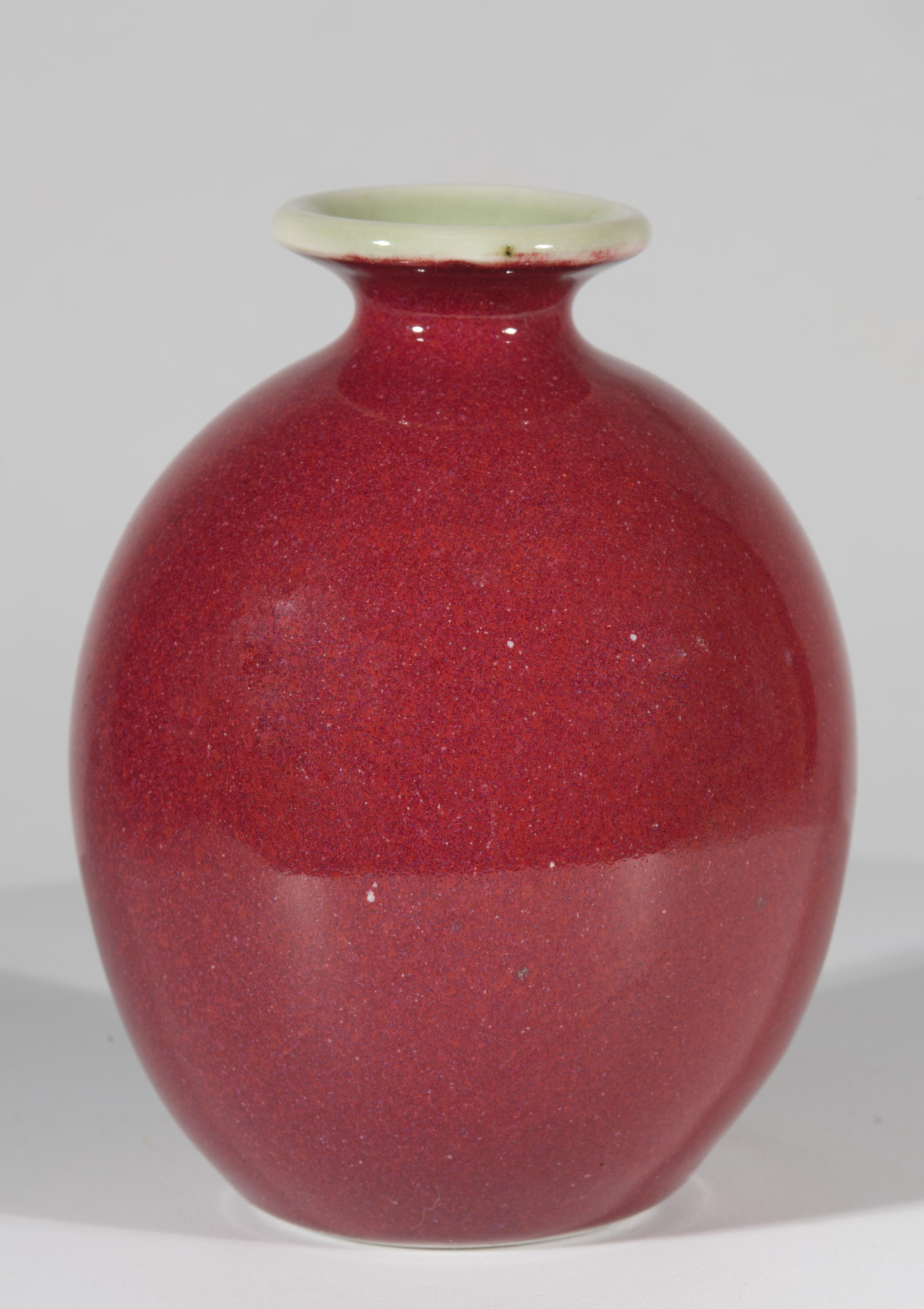 Mid-century modern ceramic vase was made in Italy for Americal importer. Its sleek and elegant form combines functional beauty and meticulous craftsmanship. The vase is finished with monochromatic glaze in complex shade of burgundy Boudreaux red.