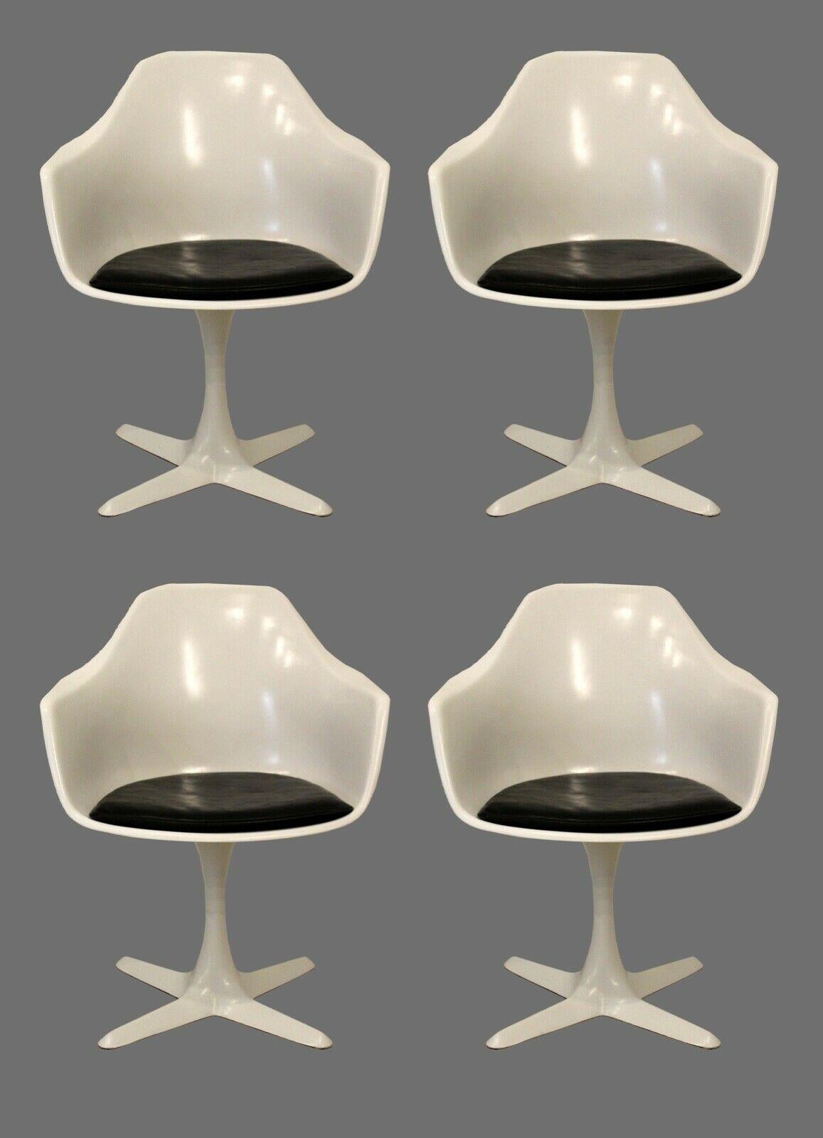 Iconic dining or kitchen set consisting of a round, tulip based table and four matching tulip base armchairs, similar to the style of Eero Saarinen for Knoll. In good vintage condition with minimal imperfections.

Dimensions: Chairs: 23 W x 23 D x
