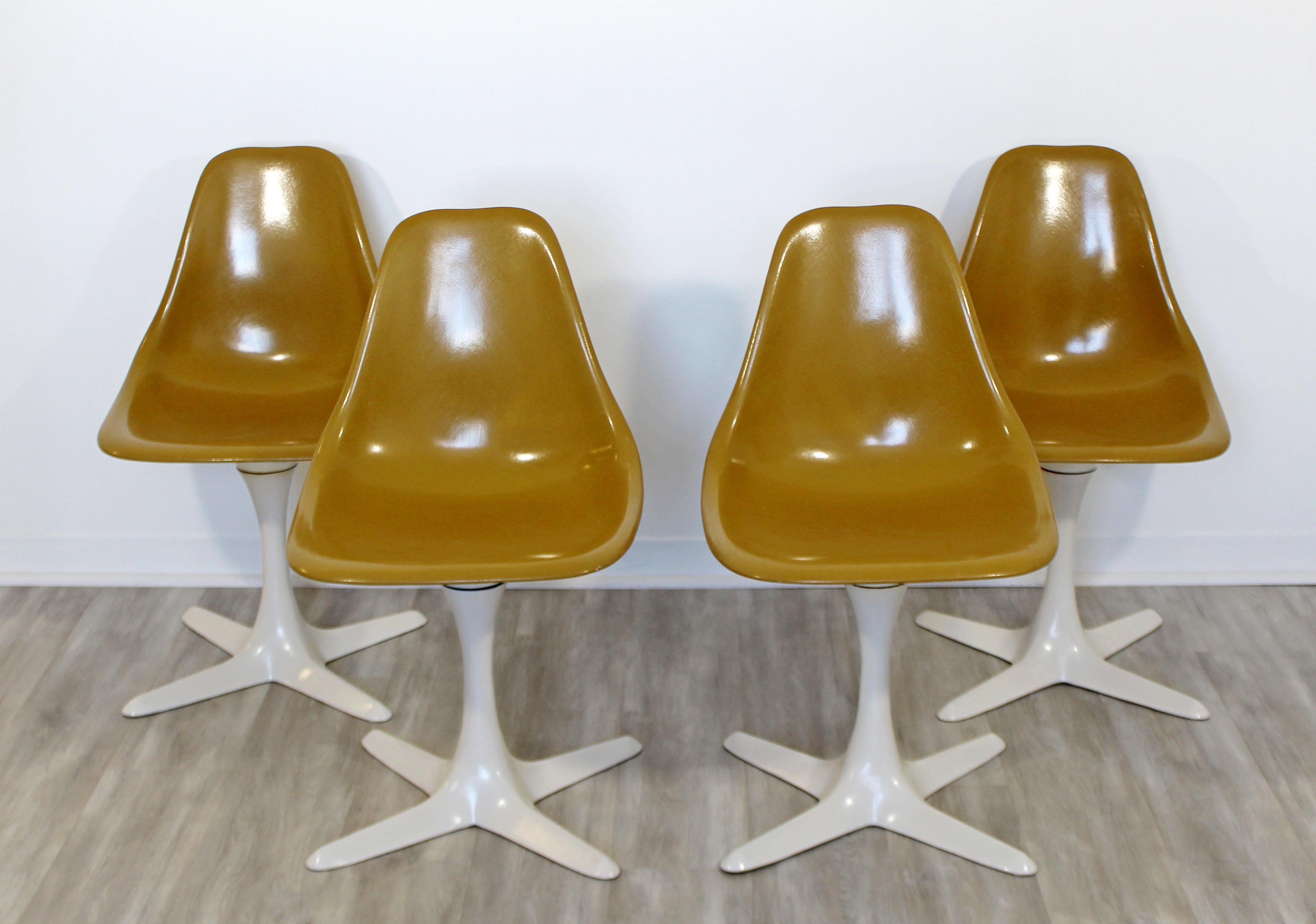 For your consideration is a chic and Classic, set of four Tulip propeller side dining chairs, with brown shell seats, by Burke, circa the 1960s. In very good vintage condition. The dimensions are 18