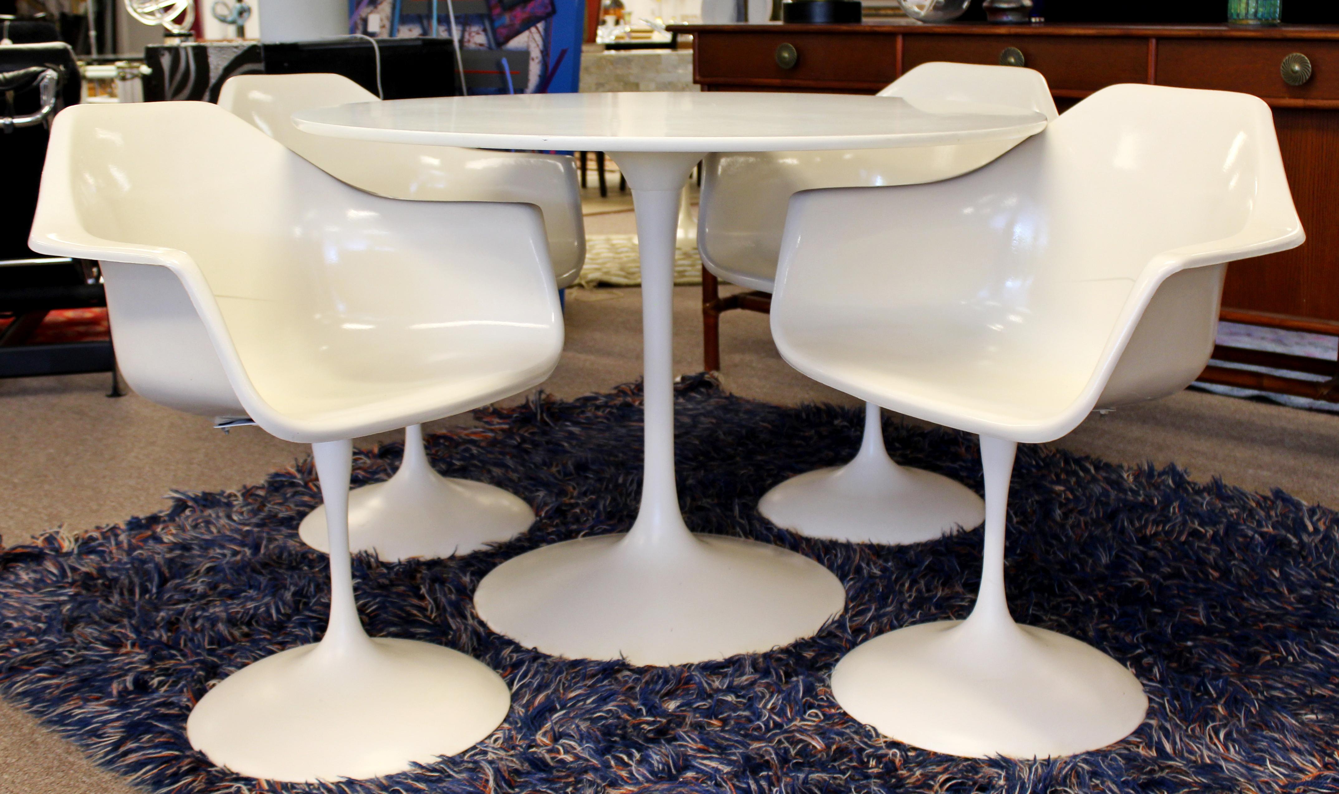 For your consideration is a spectacular, Tulip dining dinette set, including table and four dining armchairs, by Burke, circa 1960s. In good vintage condition. The dimensions of the table are 42