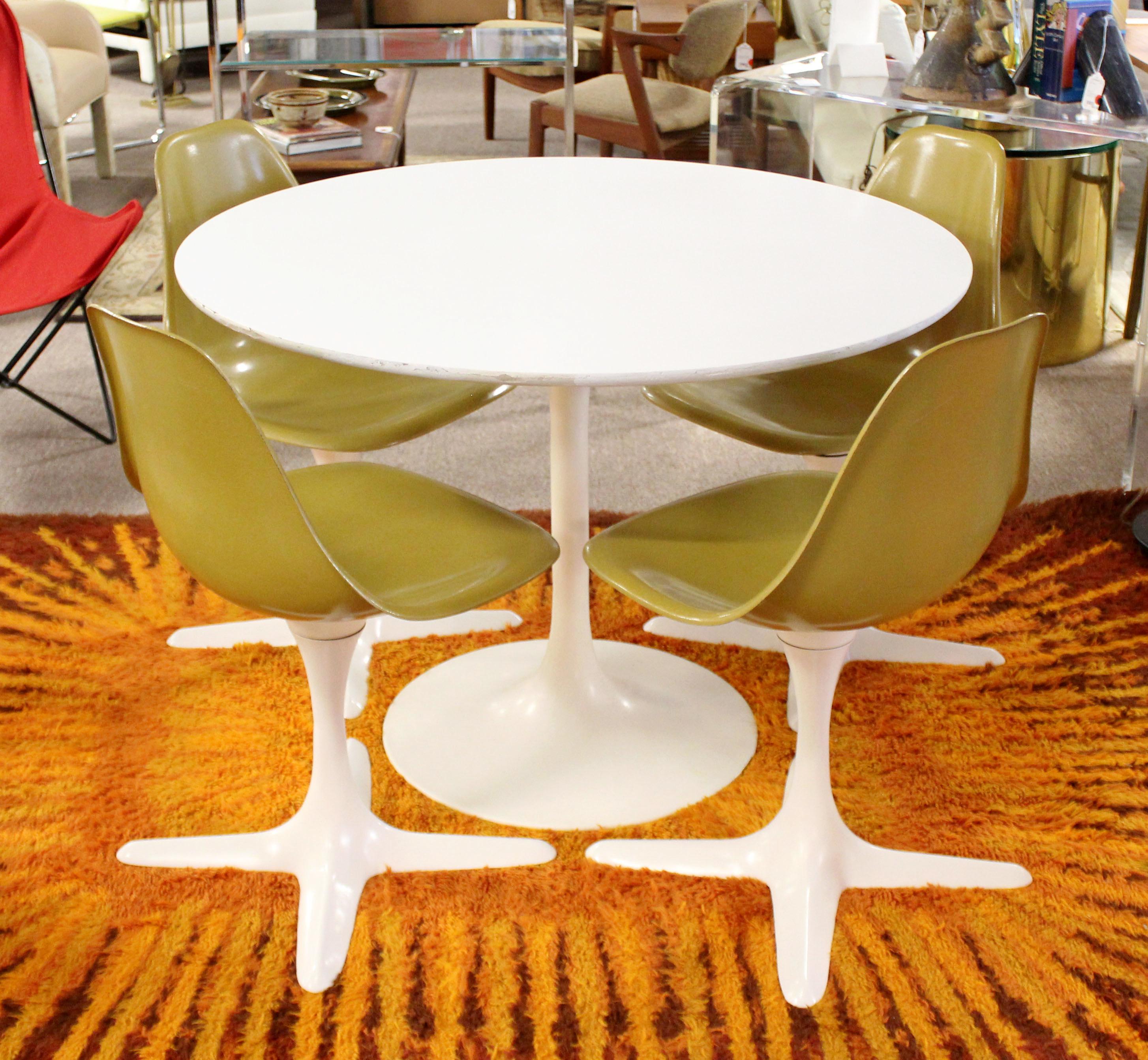 For your consideration is a stupendous, Tulip dining dinette set, including table and four propeller dining chairs that have brown shell seats, by Burke, circa 1960s. Chairs are in very good vintage condition and the table is in fair condition. The