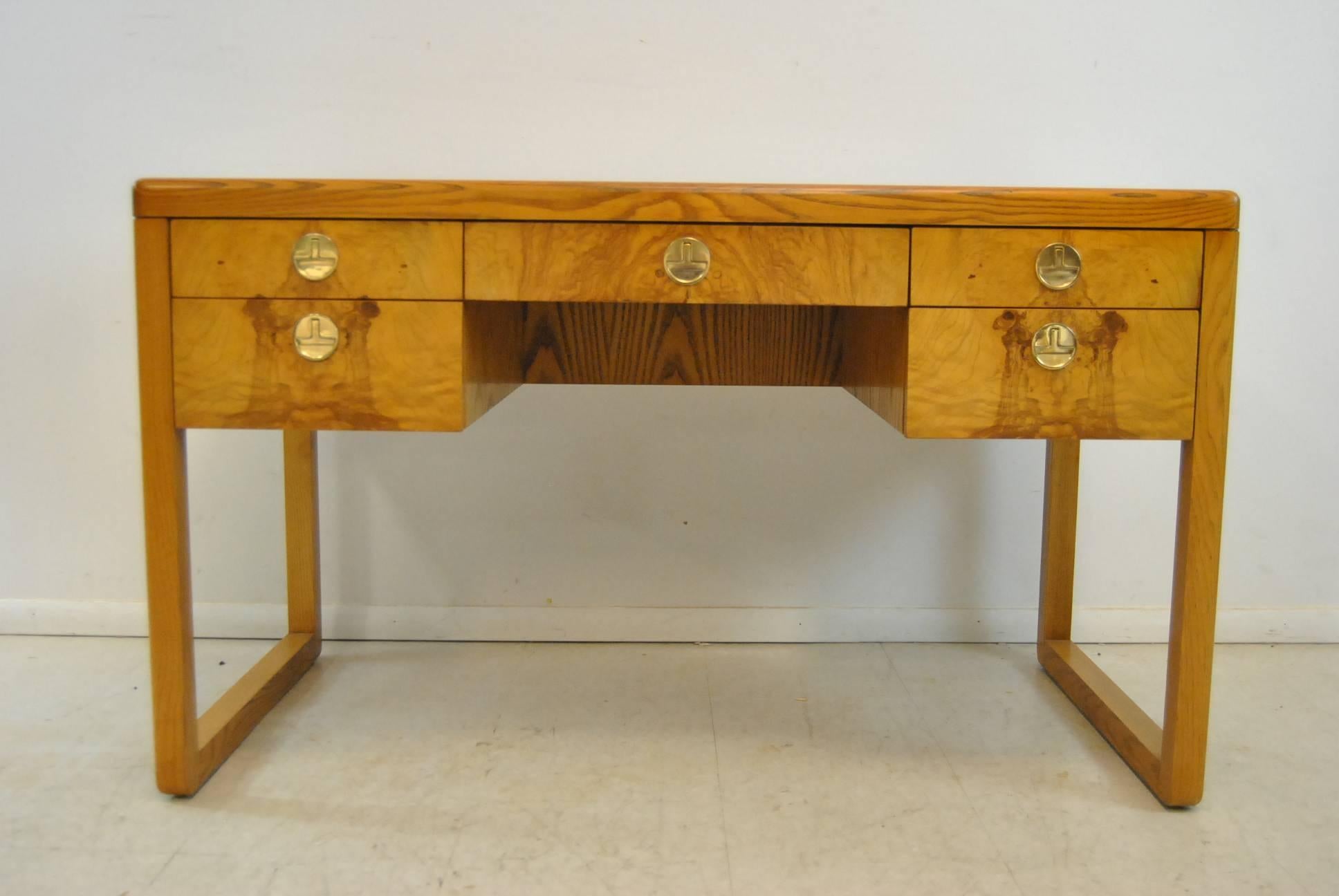 A fantastic Mid-Century Modern Desk by Sligh Furniture. From the 1960s, this burl desk features a dovetailed construction and the original brass hardware. The dimensions are 50
