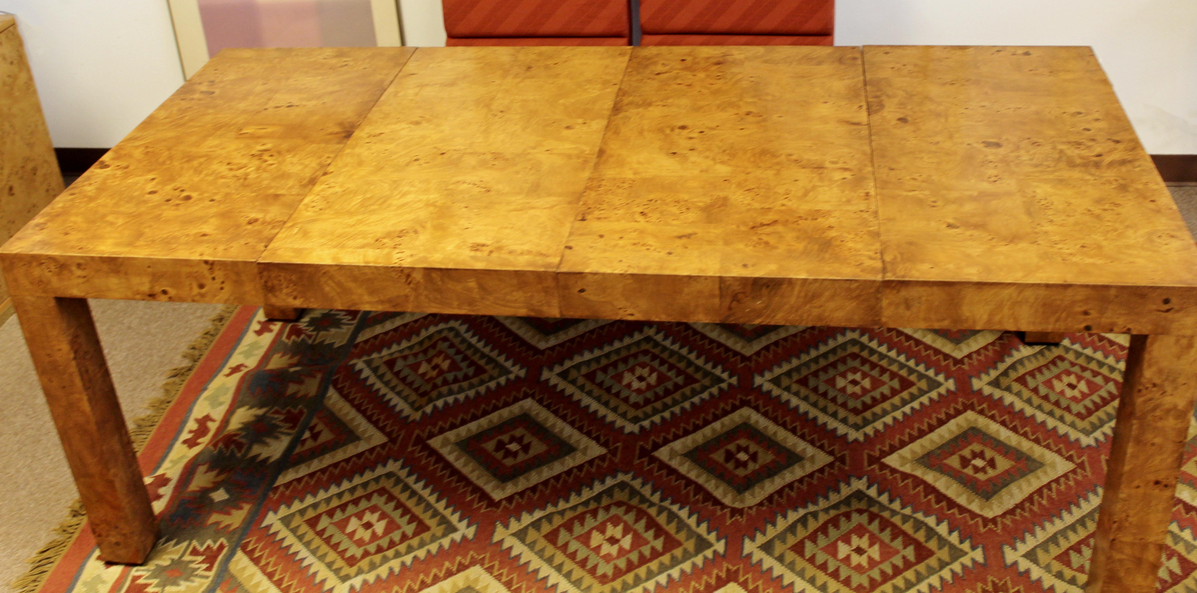 For your consideration is a remarkable, square dining table that opens with two leaves, made of burl wood, by Milo Baughman, circa the 1960s. In very good condition. The dimensions closed are 39