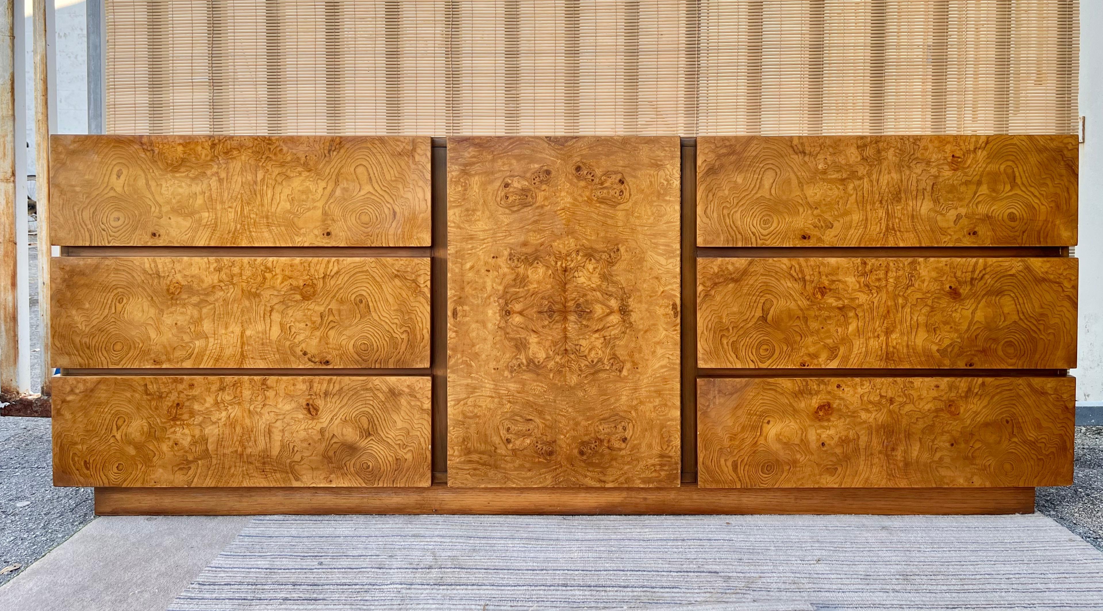 Mid Century Modern Brutalist Burl Wood 9 Drawers Dresser originally designed by Roland Carter for Lane Furniture, . Manufactured in 1971
Features a sleek minimal design with beautiful olive burl wood veneer. With three large drawers at both sides a