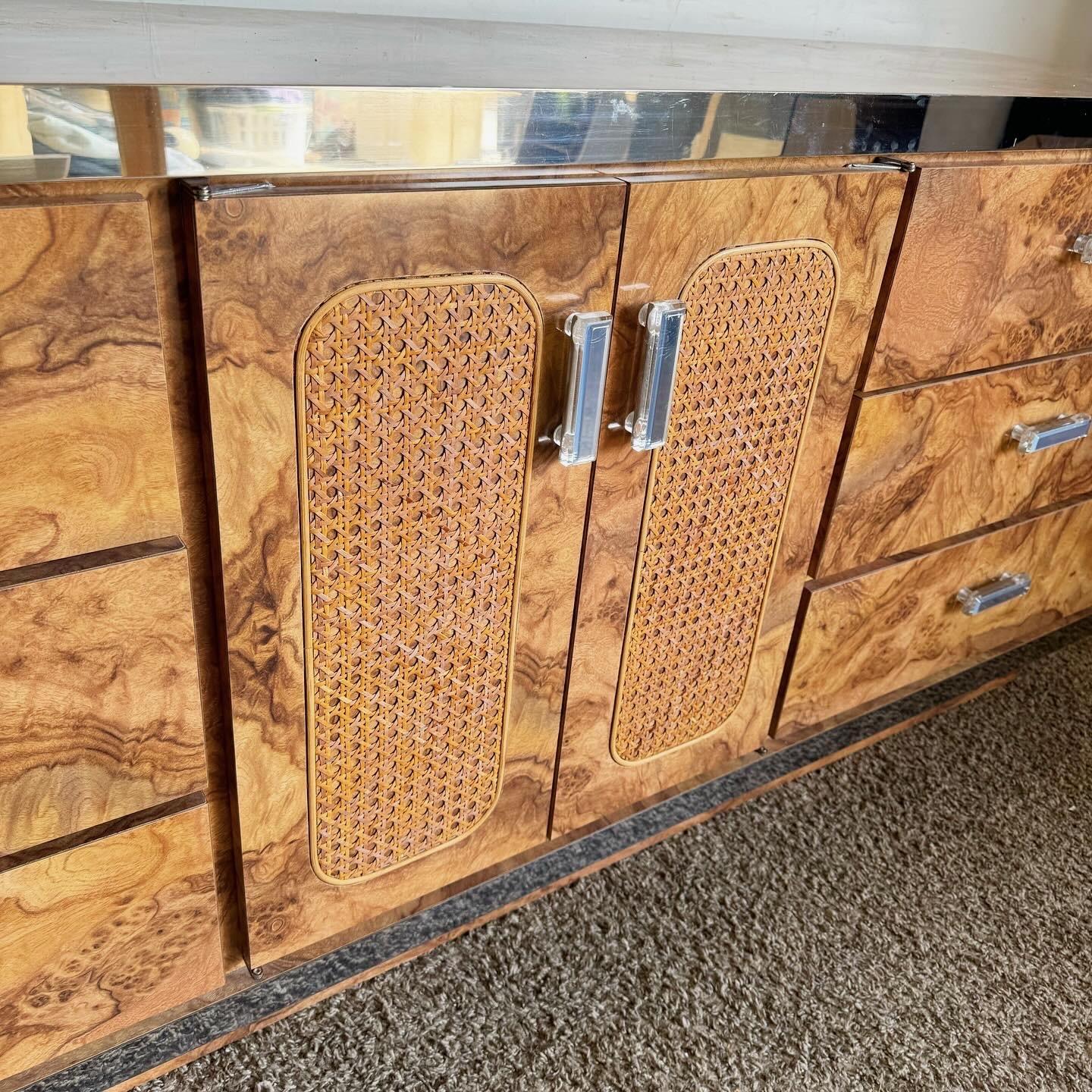 Enhance your bedroom with the Mid Century Modern Dresser Set, a perfect fusion of Burl wood laminate, cane, and chrome. This three-piece set features a spacious dresser and two matching mirrors, each embodying mid-century design with a modern twist.