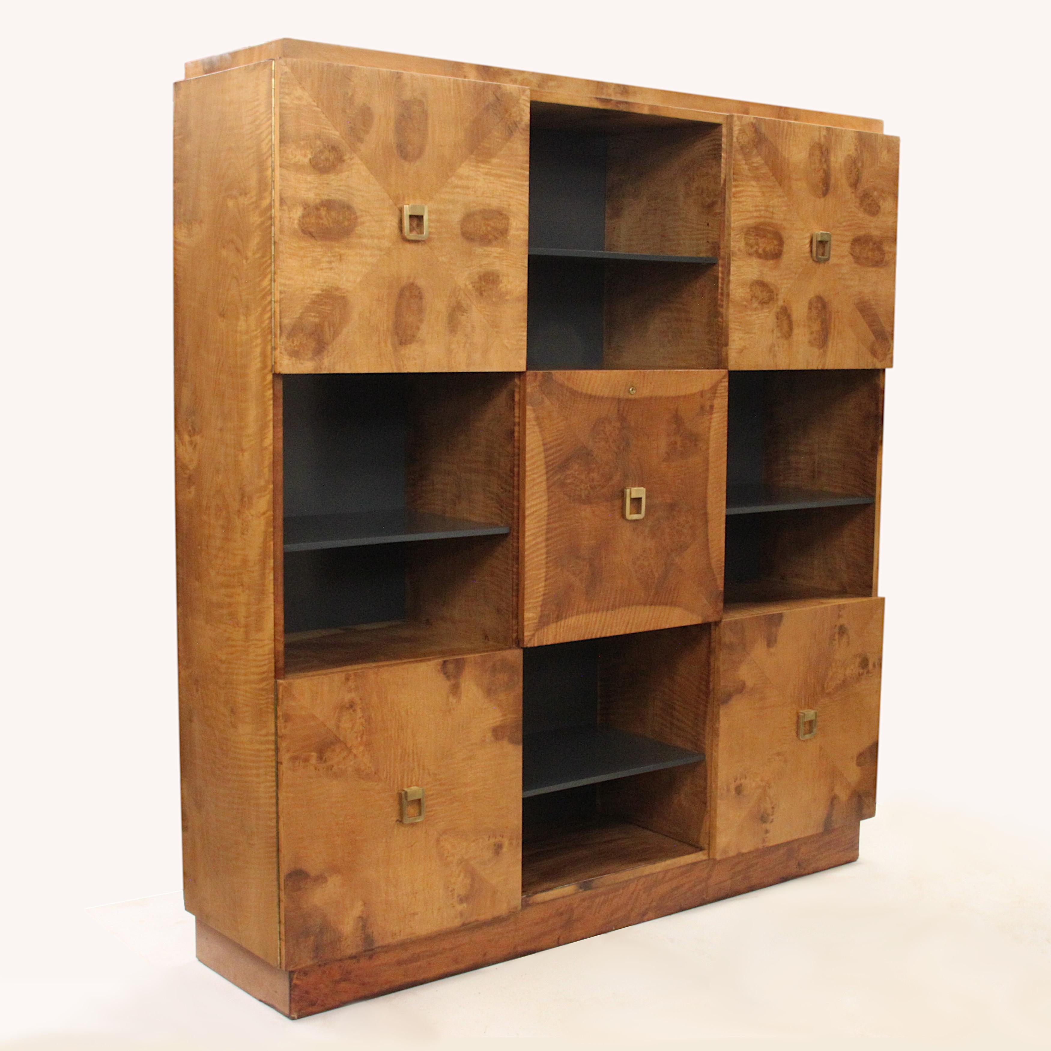 Spectacular burled cabinet/wall unit designed by Johan Tapp for Gumps. 
Cabinet features beautiful book-matched burl veneered doors, solid brass hardware and unique, center fold-down desk/cubby. A striking Mid Century piece with equal amounts of