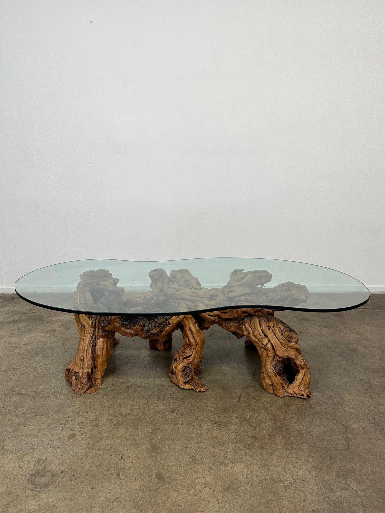Designed in the 1960s in the United States this coffee table features a burled base, driftwood, and glass. This item is in overall good vintage state. Please refer to images for further detail on wear and condition. 



