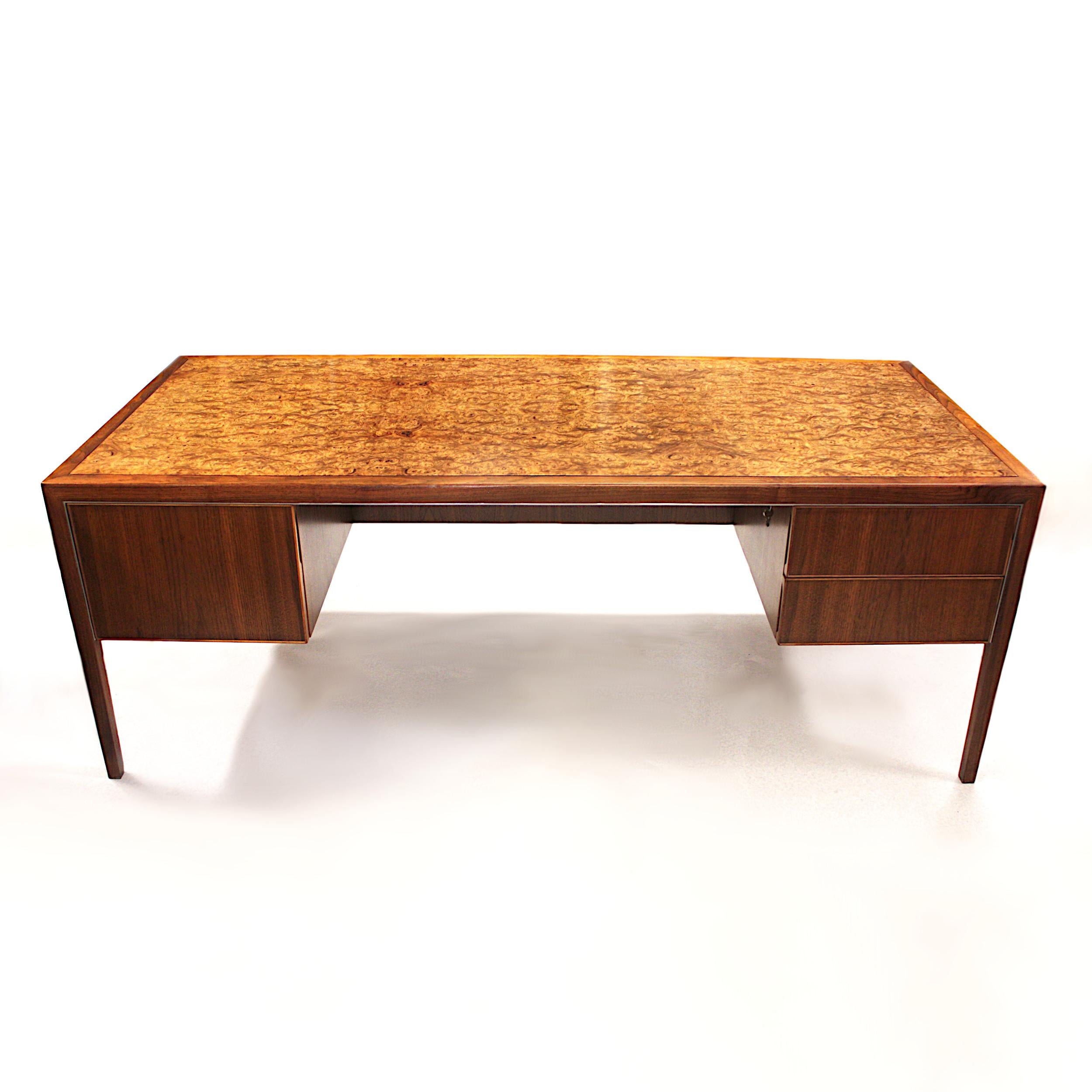 This wonderful Mid-Century Modern desk by Stow Davis is full of unique features. With its beautifully clean lines, Burled oak top, and touch of polished aluminum accents, it is the epitome of 1970s chic. Stow Davis is renowned for its quality and