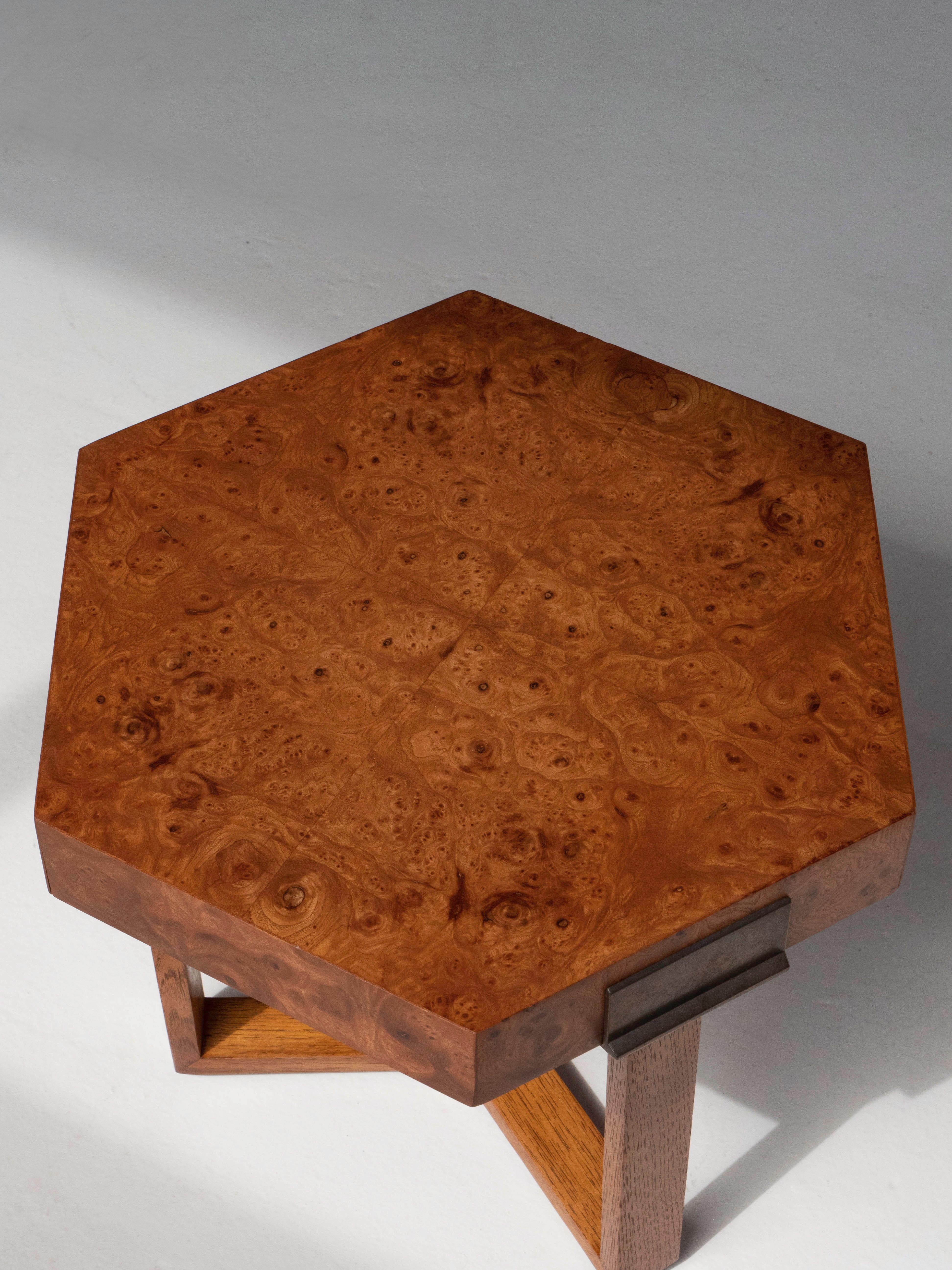 A hexagonal shaped side / cocktail table with a burlwood top and brass accents. The table is attributed to designer Milo Baughman for Bernhardt Furniture - Flair Division. Made circa 1970's. The table is in excellent condition and has been lightly