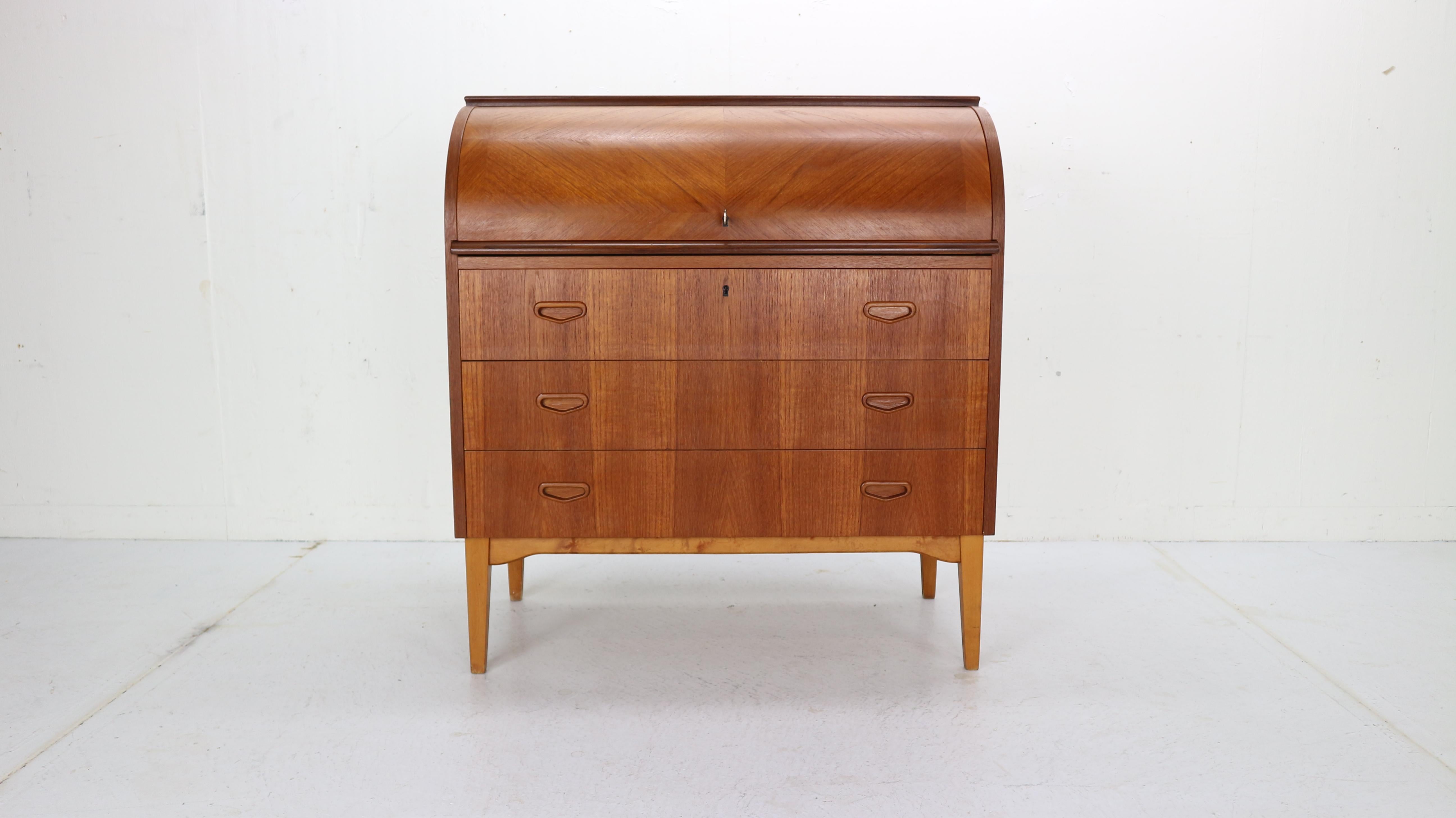 This iconic midcentury Swedish modern teak cylinder rolltop secretary- desk- cabinet is made in 1970s Sweeden by Egon Ostergaard designer and manufactured by Markaryds Mobelindustri manufacture.
The Classic Scandinavian Modern design has clean