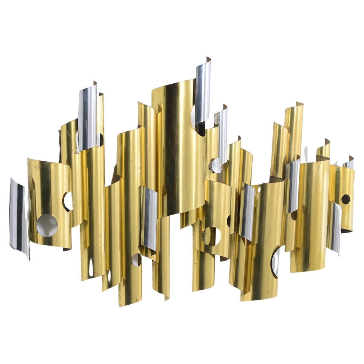 This extraordinary 1960s mid-century modern contemporary wall sculpture is by C. Jere. is in great condition executed out of brass and steel and finished in chrome, newly cleaned and polished developing a beautiful vintage luster patina finished
