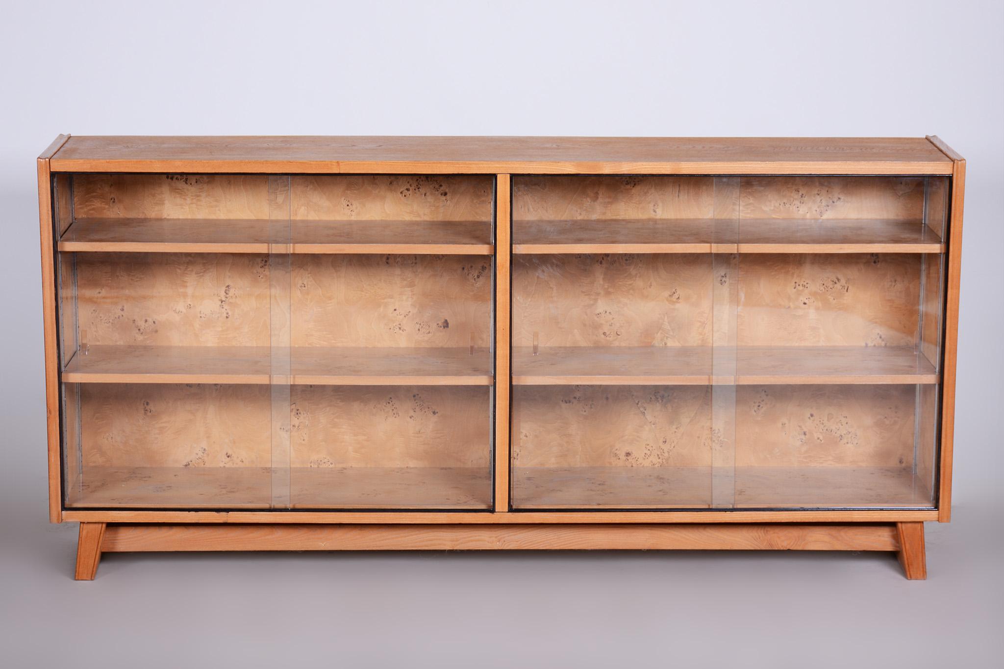 The cabinet has been fully restored by our professional refurbishing team in Czechia according to the original process. 

Sold individually. 

This item features classic Mid-Century Modern (MCM) design elements. Elements of MCM interior design