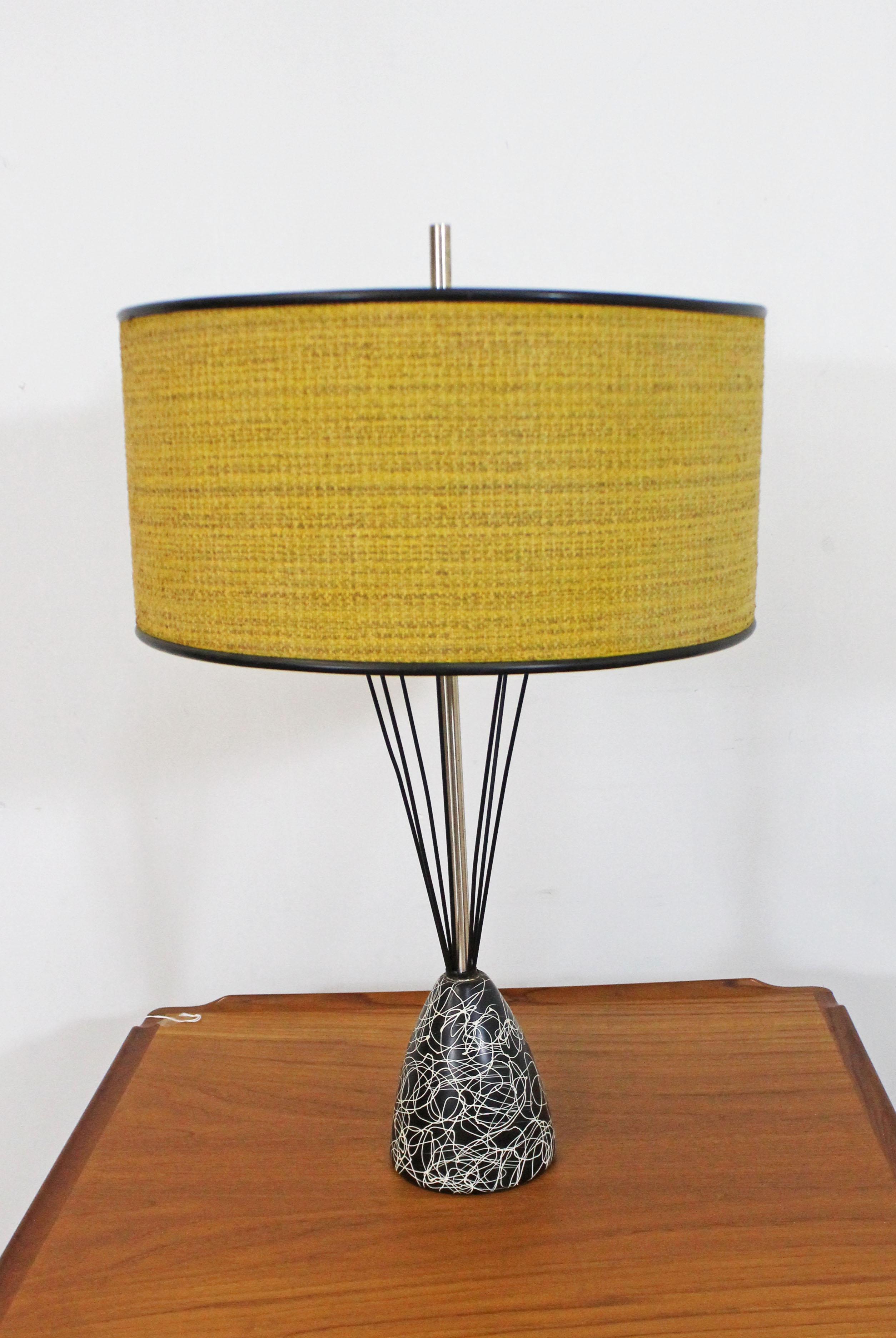 Offered is a one-of-a-kind retro Mid-Century Modern table lamp with a caged wire-base and drum shade. This lamp has a painted metal and wire base. The drum shade sits on a glass shade (see photos). In good, working condition with a short wire. Shows