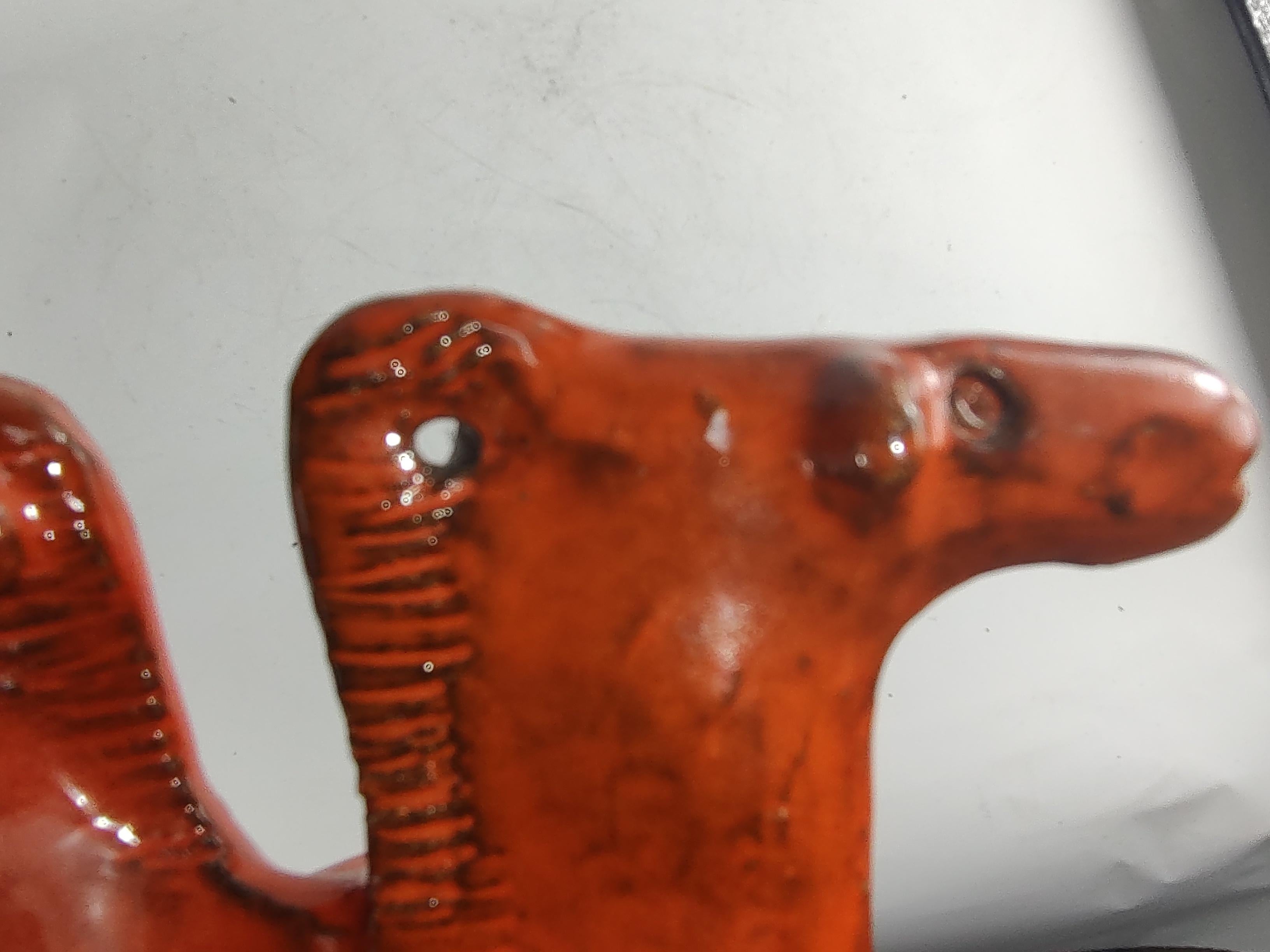 Fabulous Sculptural stoneware abstract object with a two headed camel atop round pillar with impressions in a mid sixties orange. In excellent condition with no visible chips or cracks. Aldo Londi for Bitossi c1965
