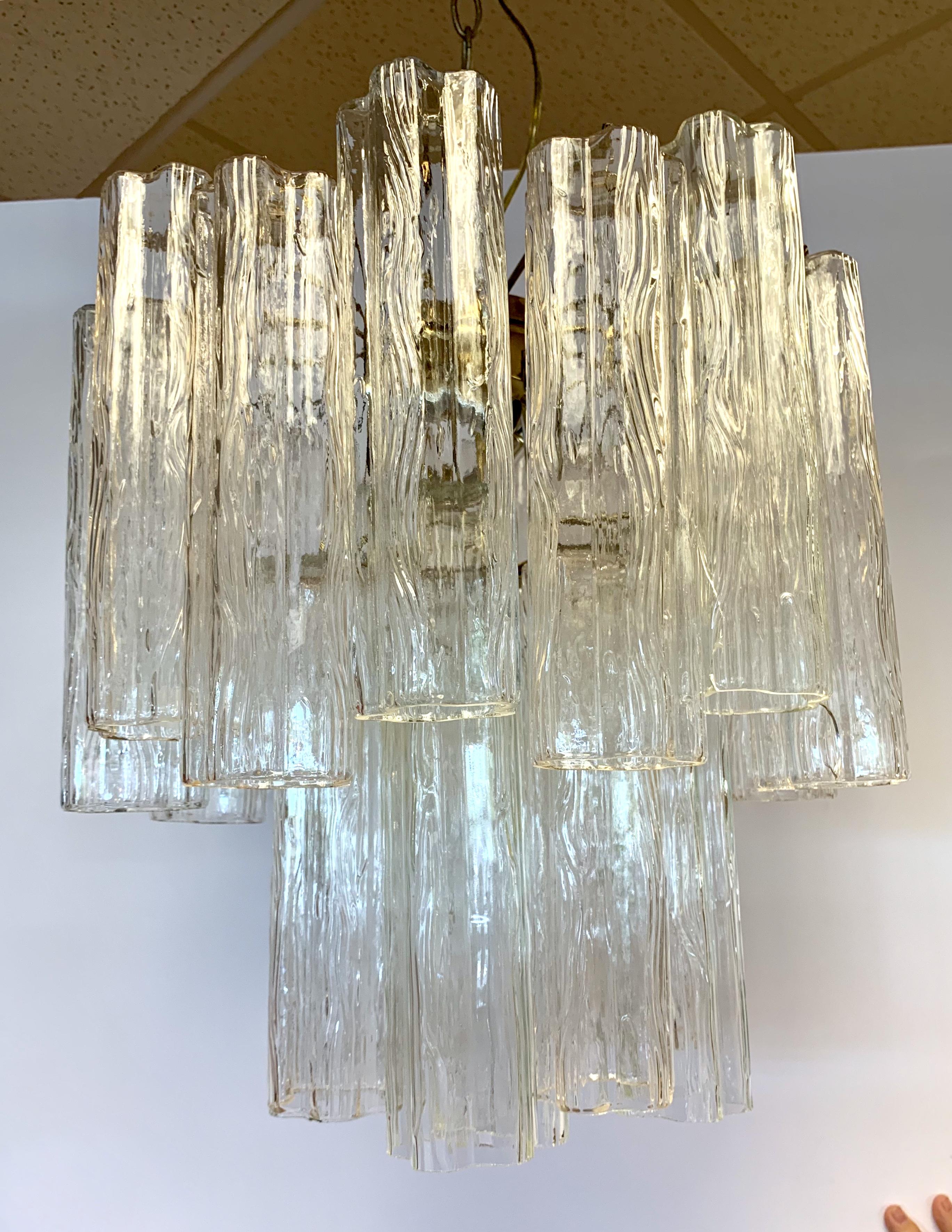 Mid-Century Modern venini glass chandelier is made of textured glass tubes that look like flowers when looked at from below. Made in Italy.
Wired for USA and in perfect working order.
