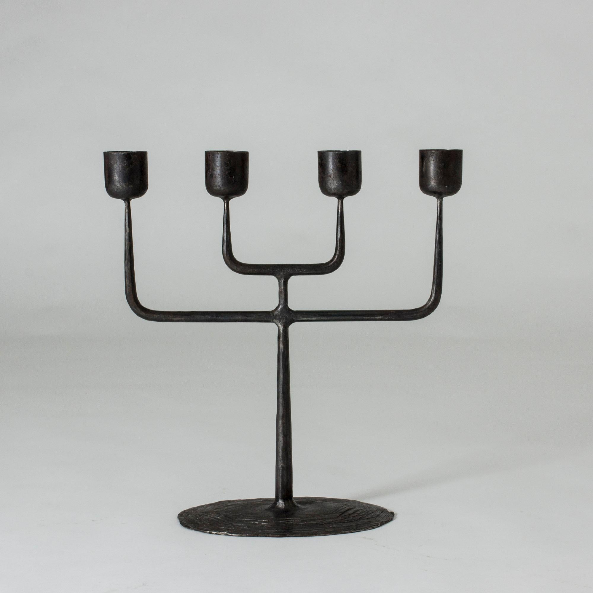 Striking wrought iron candelabra by Erik Höglund, made for 5 cm wide candles, but also fits regular size candles. Cool, stark shape with a both modernist and traditional expression.

Erik Höglund was lead designer at Boda Glassworks during the