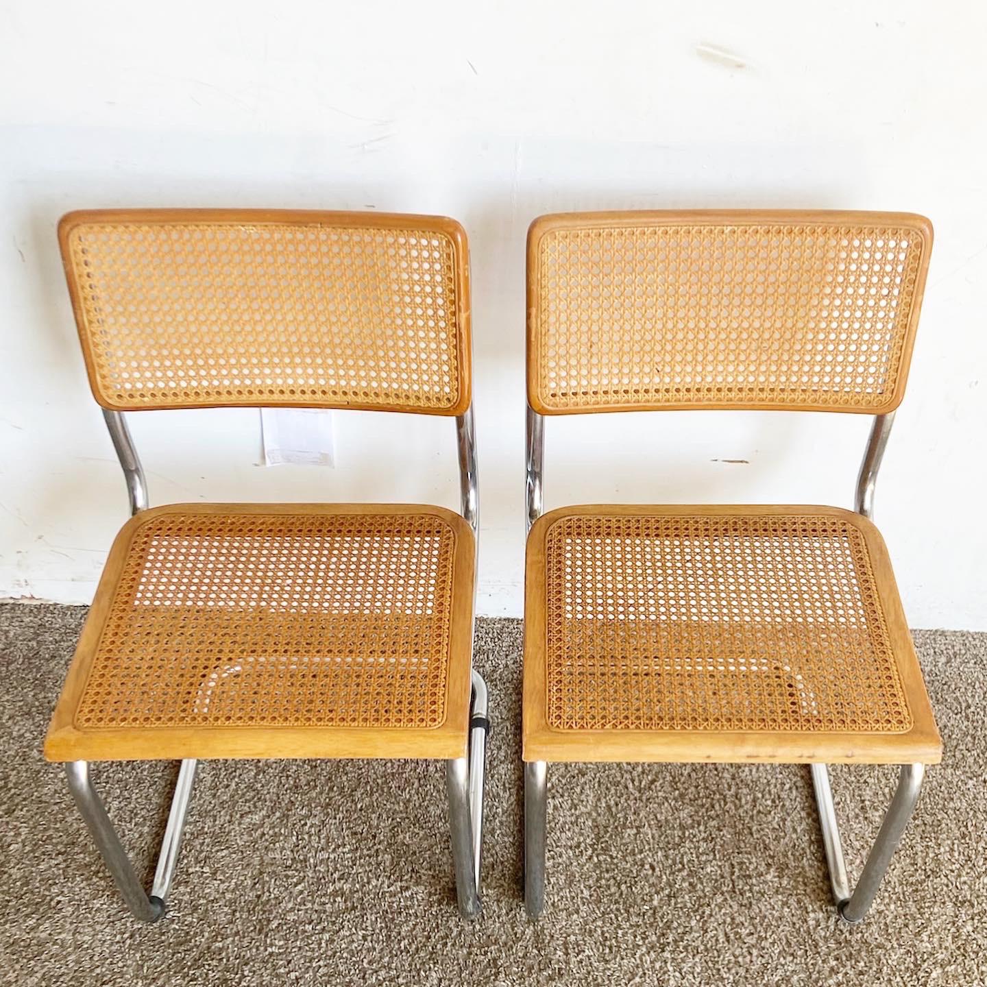 Elevate your dining room with this pair of Mid Century Modern Cane and Chrome Cantilever Dining Chairs. These chairs masterfully combine chrome frames and cane backrests in an iconic cantilever design, offering a blend of modern aesthetics and