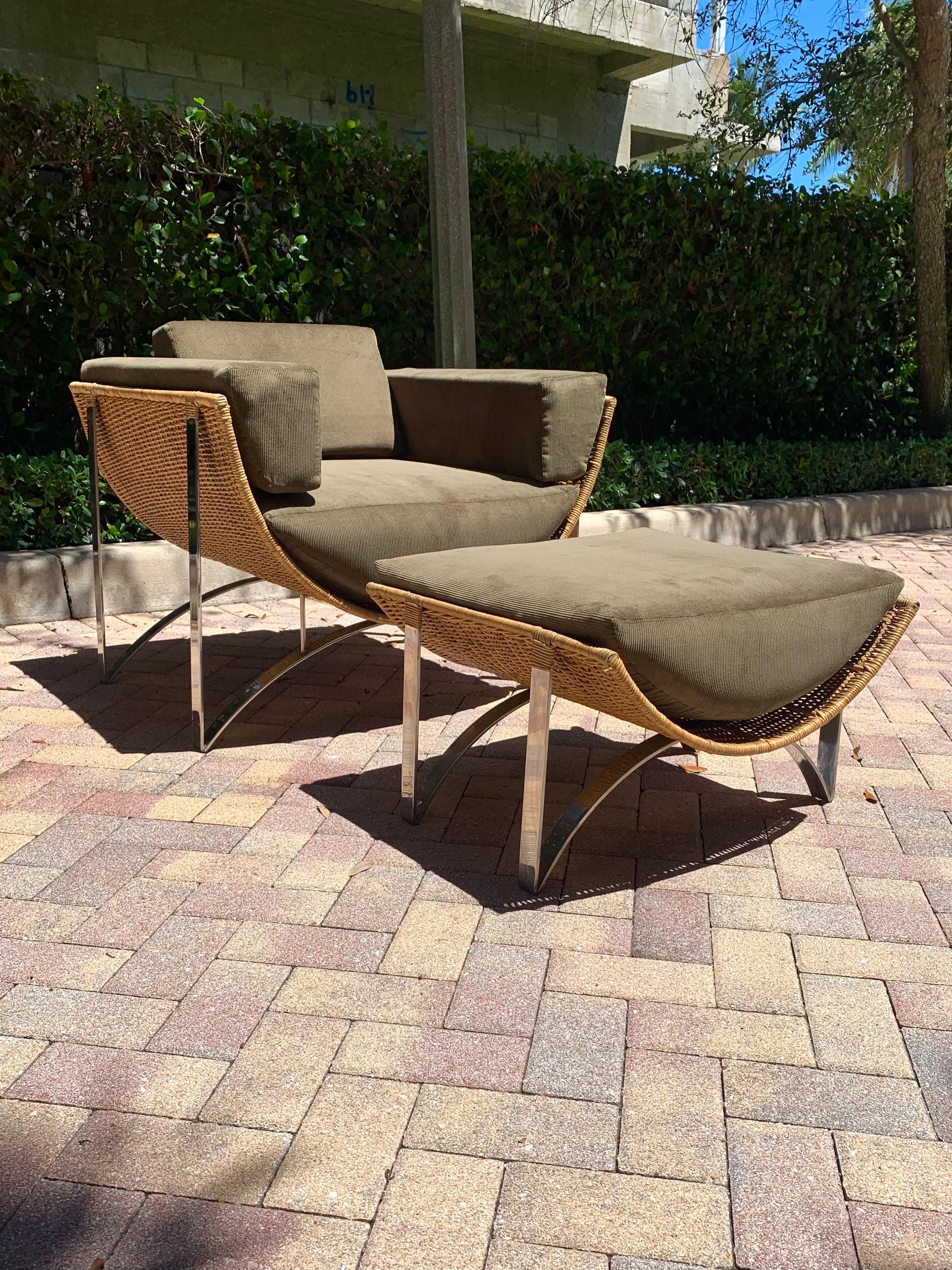 Lounge chair and ottoman in Cane and Chrome. Strong beautiful flowing lines make up the design of the chair. A cane hammock supporting the puzzle piece like cushions. Freshly upholstered in a soft corduroy accenting the colors and lines of the chair