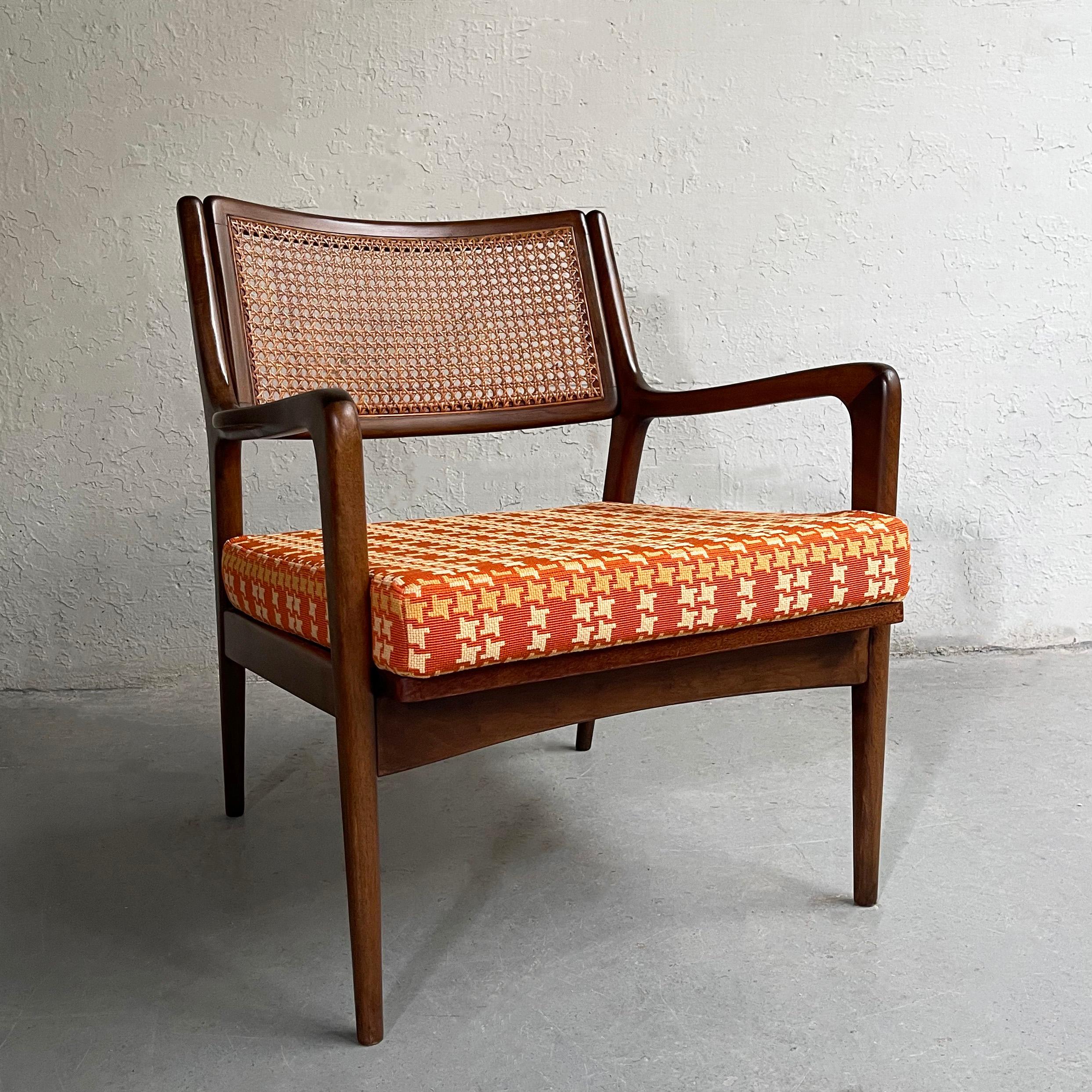 Wonderfully, detailed, Mid-Century Modern, walnut armchair features a caned back and newly upholstered seat cushion in a vibrant linen blend houndstooth.