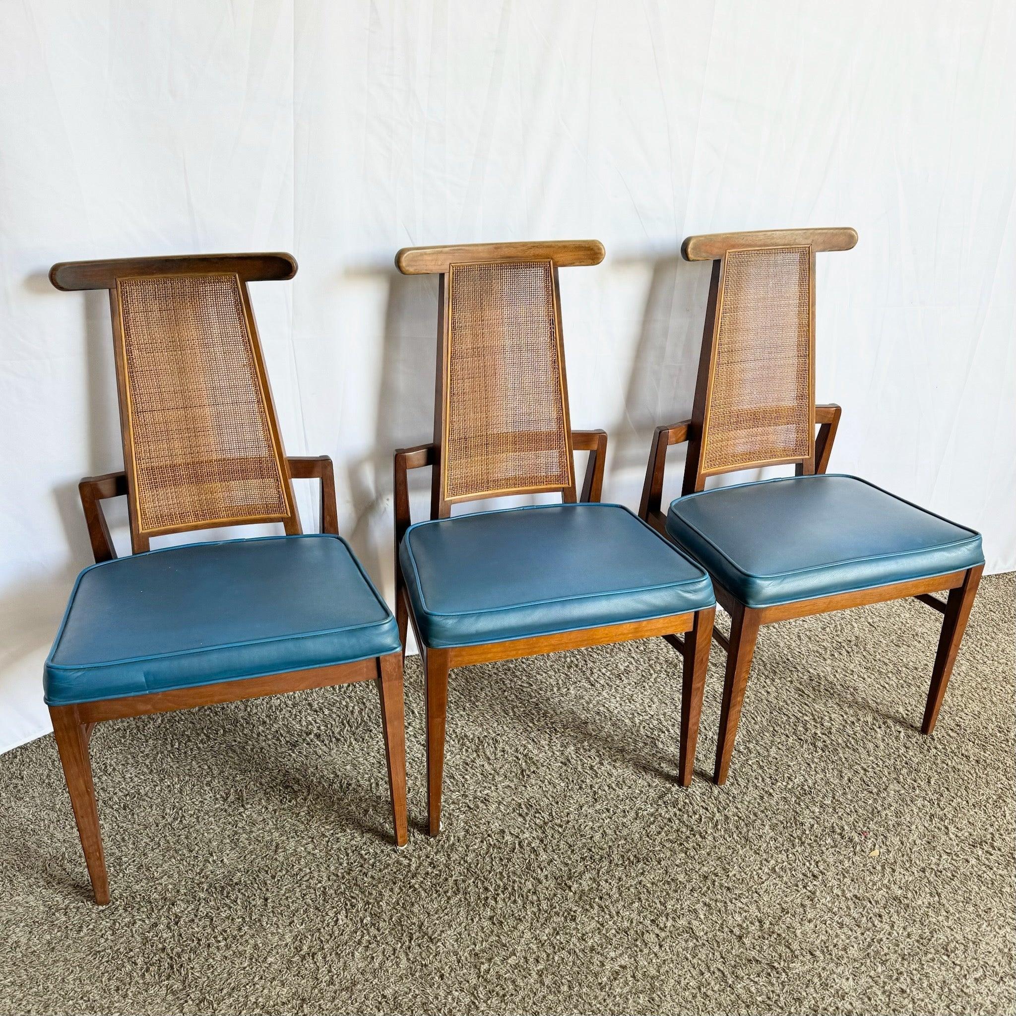 Mid-Century Modern Cane Back Dining Chairs by Foster McDavid—walnut frames with airy cane backs, embodying 1960s American design elegance.​
 
 Some cracks to the wood that has been repaired as shown in the phone.
