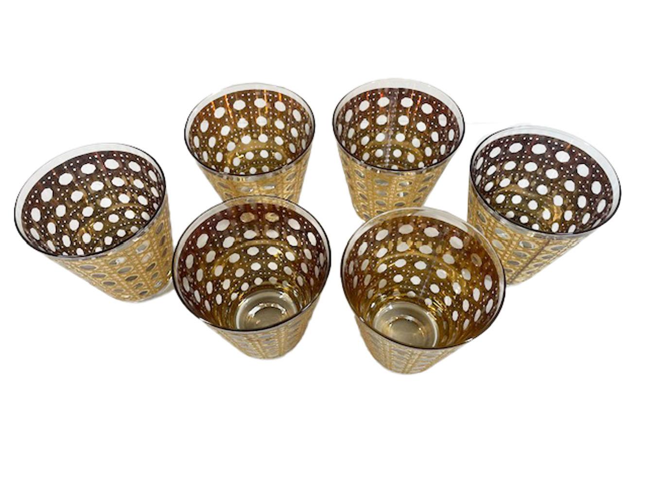 Six double old fashioned glasses in the 'Canella' pattern by Culver, LTD. Decorated in a woven cane pattern of 22 karat gold with smooth and textured finishes.