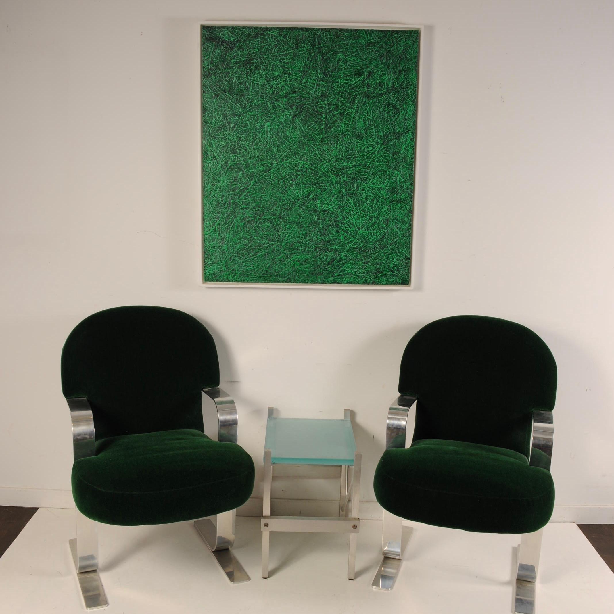 Clean pair of cantilevered armchairs in hunter green mohair with heavy, polished steel arms and legs. A nice blend of Art Deco with a modern Brueton-like polished frame. The design of the legs is rather unique to this chair. Haven't seen this design