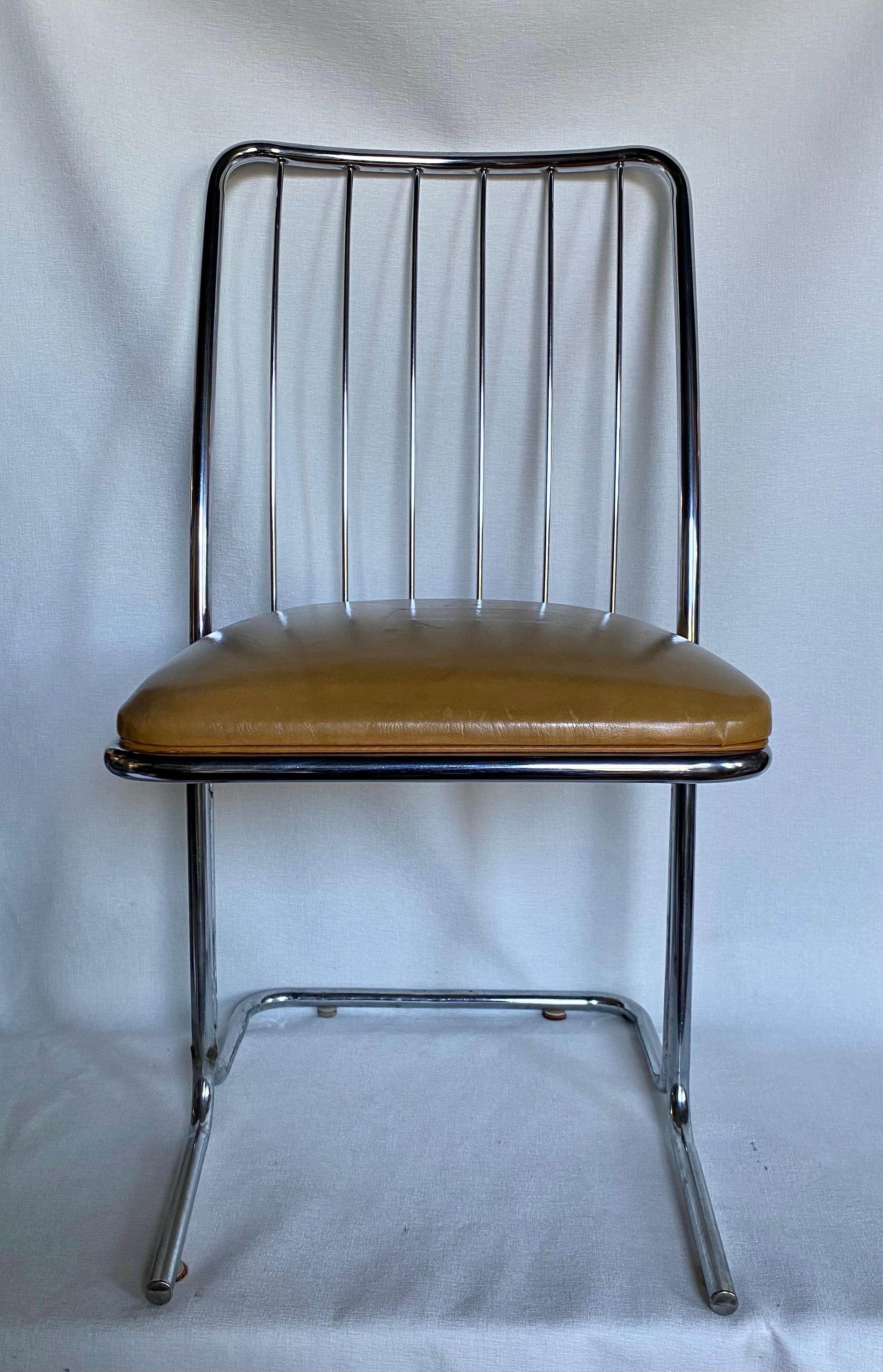 Set of six Mid-Century Modern chrome dining side chairs featuring a cantilevered tubular metal frame and a wire back design. These sculptural armless dining chairs are manufactured by Daystrom Furniture. Original vinyl upholstery. Chairs dated