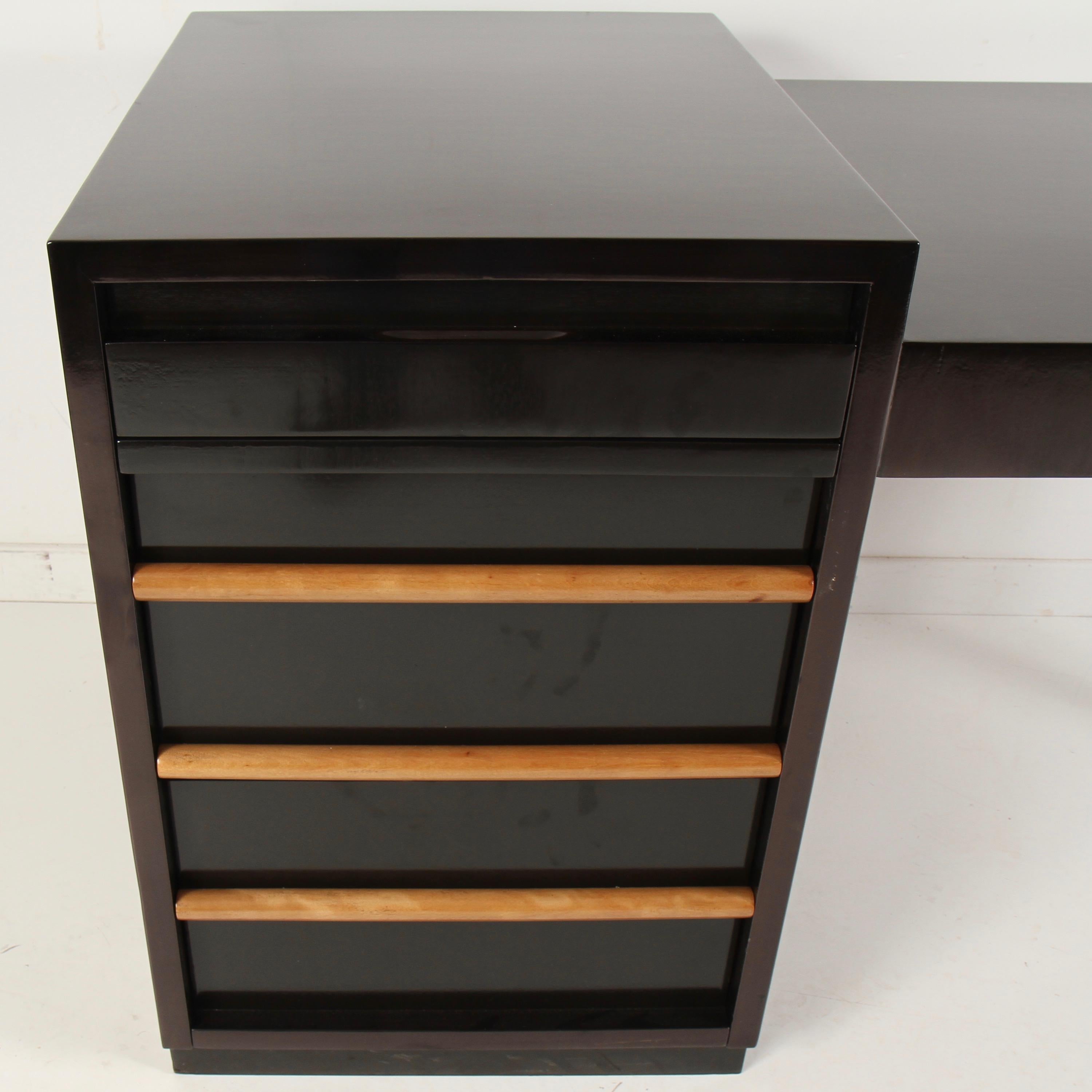 This may be the coolest desk design Robsjohn Gibbings ever did. Refinished in a dark walnut, almost ebony, open-grained finish, with contrasting clear stained drawer pulls. Really well thought out desk interior with plenty of room for any office