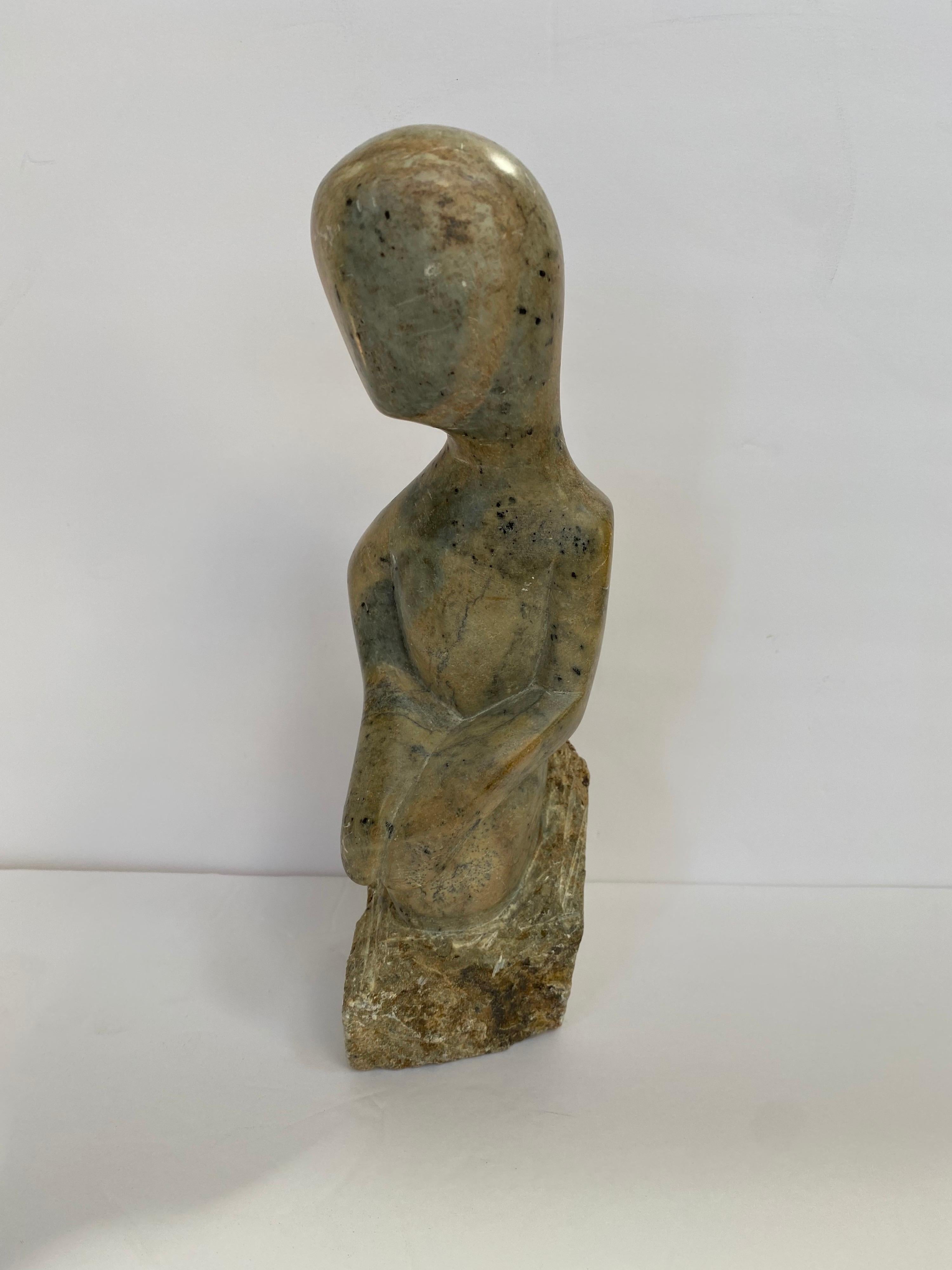 Mid-Century Modern marble figural form sculpture. This decorative object is carved from a single piece of stone.