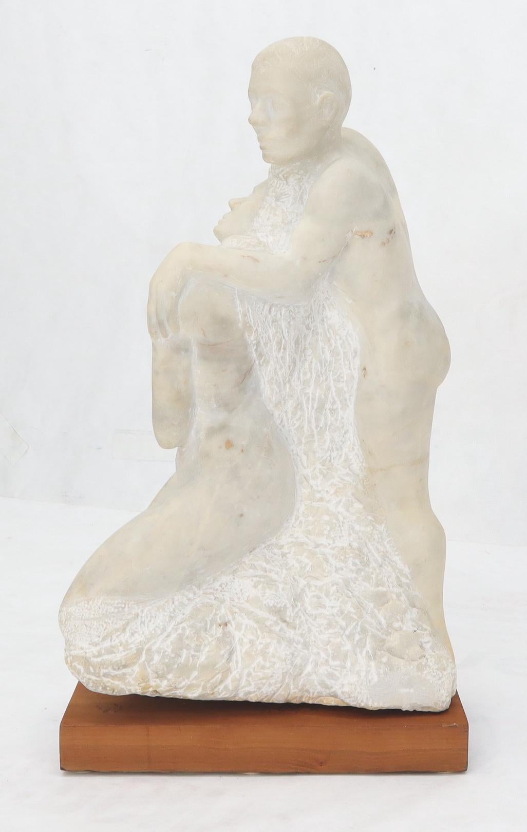 Carved marble sculpture of hugging nude male and female.