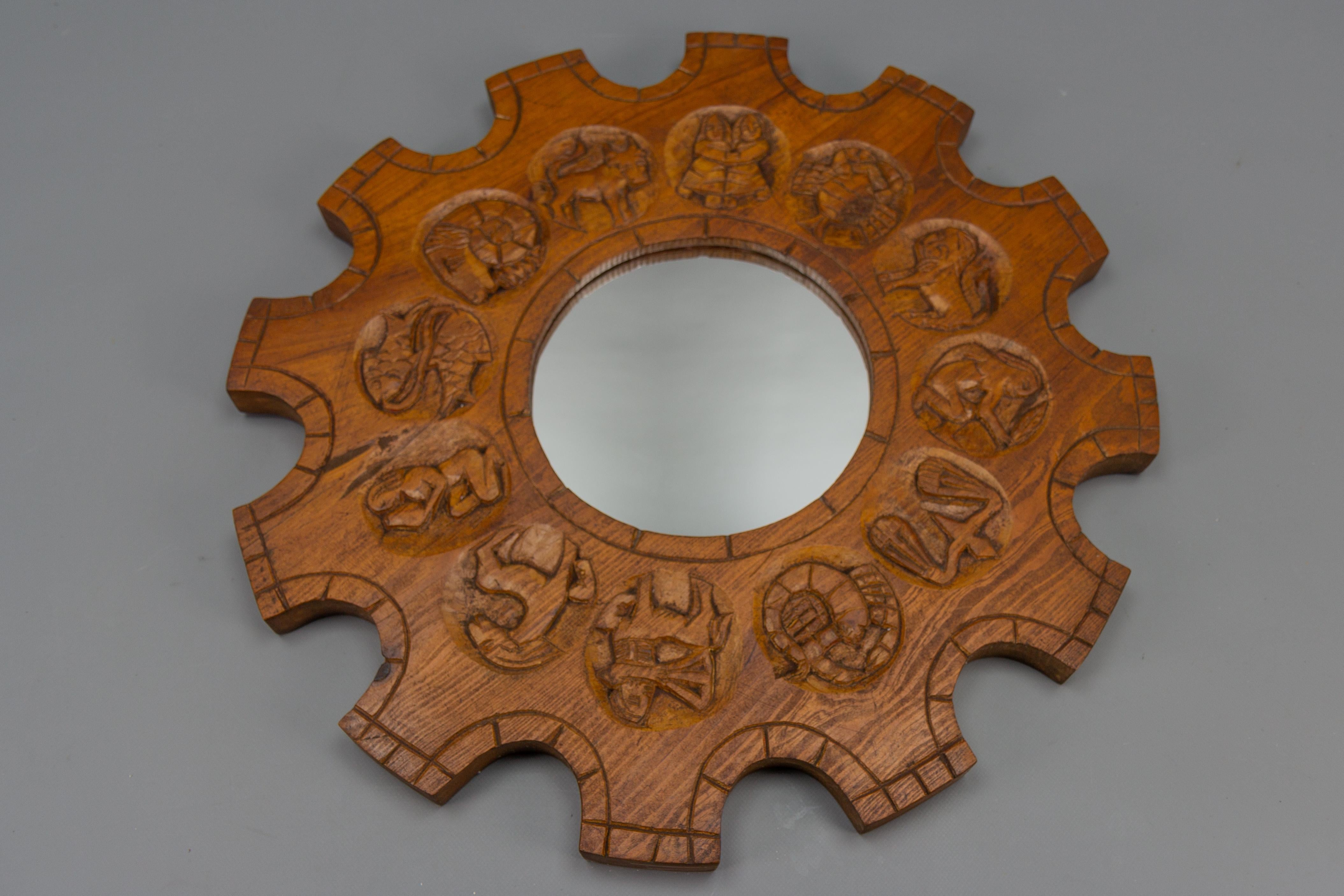 Mid-Century Modern carved pine-wood sunburst-shaped wall mirror with Zodiac signs, Germany, ca 1970s.
This massive vintage round wall mirror features a pine-wood frame with hand-carved Zodiac signs.
Dimensions: depth: circa 3.5 cm / 1.37 in;