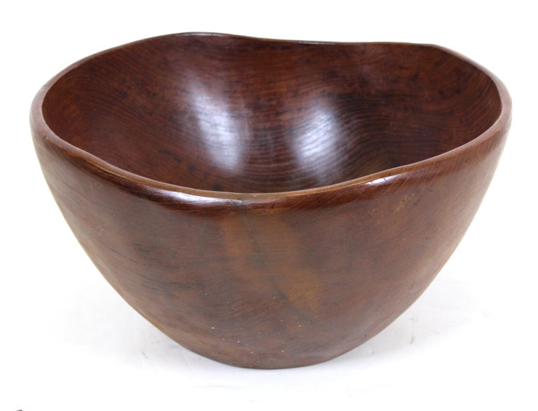 Mid-Century Modern oversized bowl in carved teak wood, with label on the bottom. Measures: 8