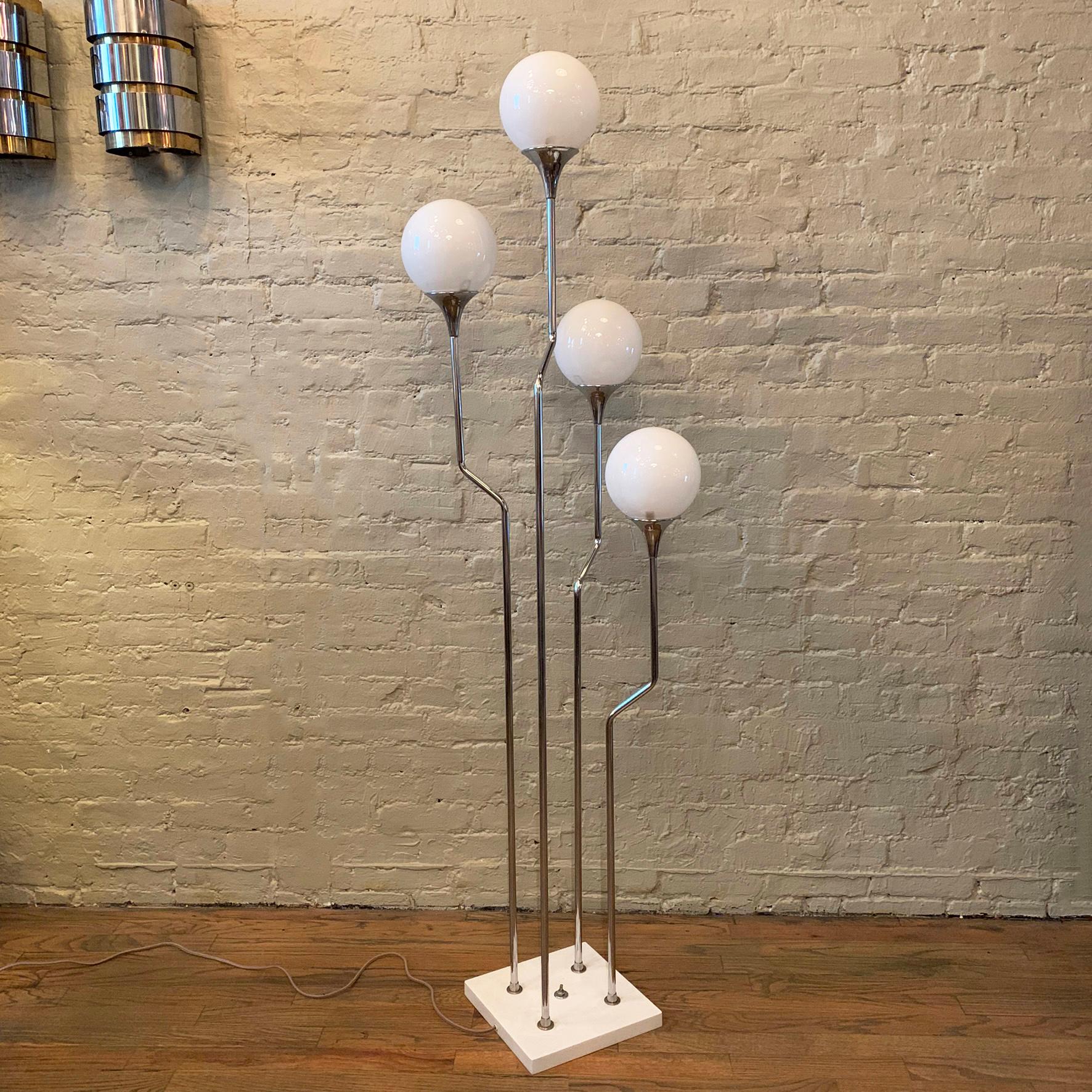 Mid-Century Modern, floor lamp features four cascading chrome stems on a painted metal base with 4 milk glass globe shades. The lamp lights two alternate bulbs at a time and then all four.