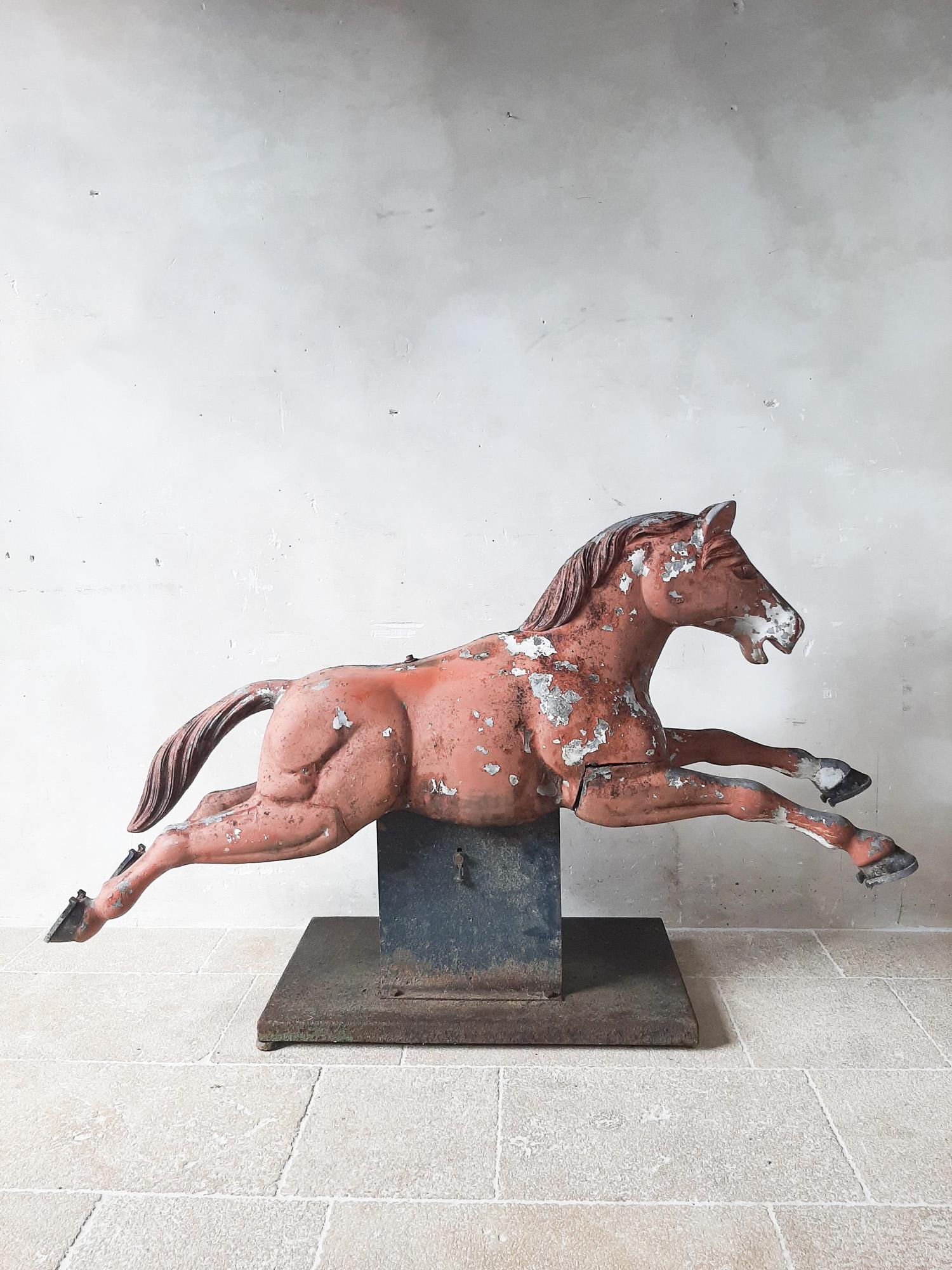 Sculpture de cheval de foire en fonte d'aluminium du milieu du siècle, avec patine polychrome d'origine sur un socle en fer forgé avec mécanisme de mouvement.

hauteur 120 x l 185 x p 60 cm.