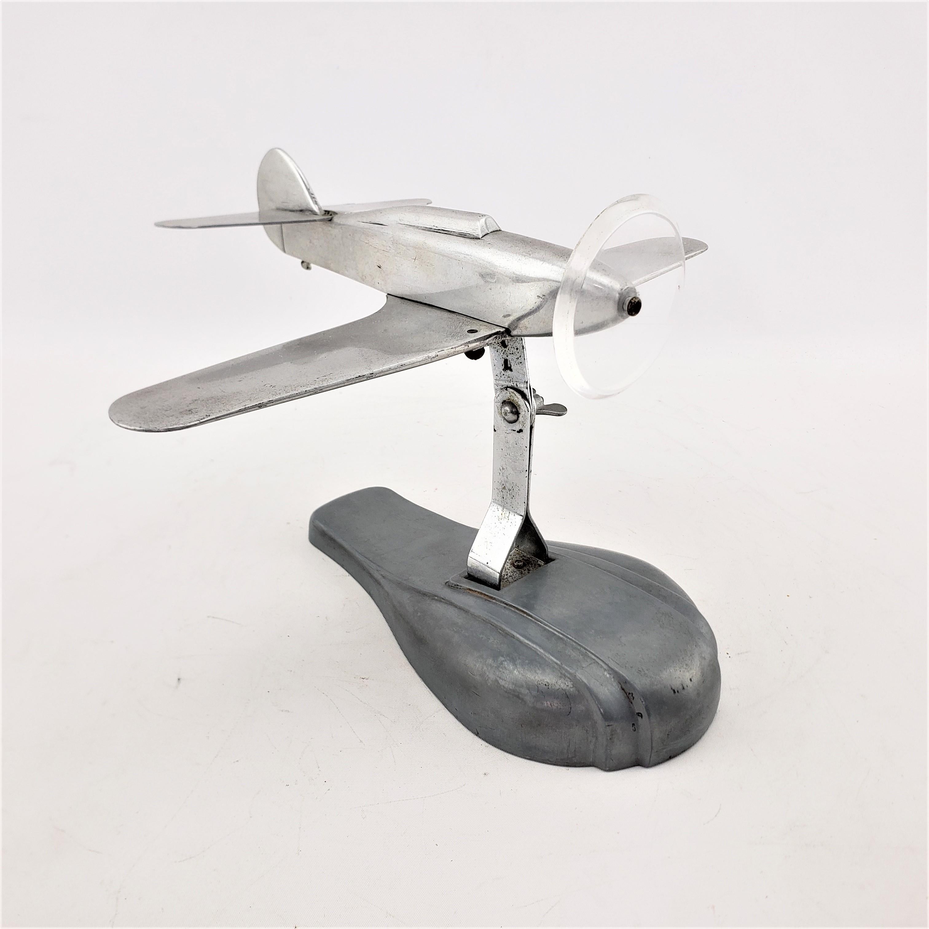 This airplane model or sculpture is unsigned, but presumed to have originated from the United States and dating to approximately 1945 and done in the period streamlined Mid-Century Modern style. The plane is composed of cast and brushed aluminum