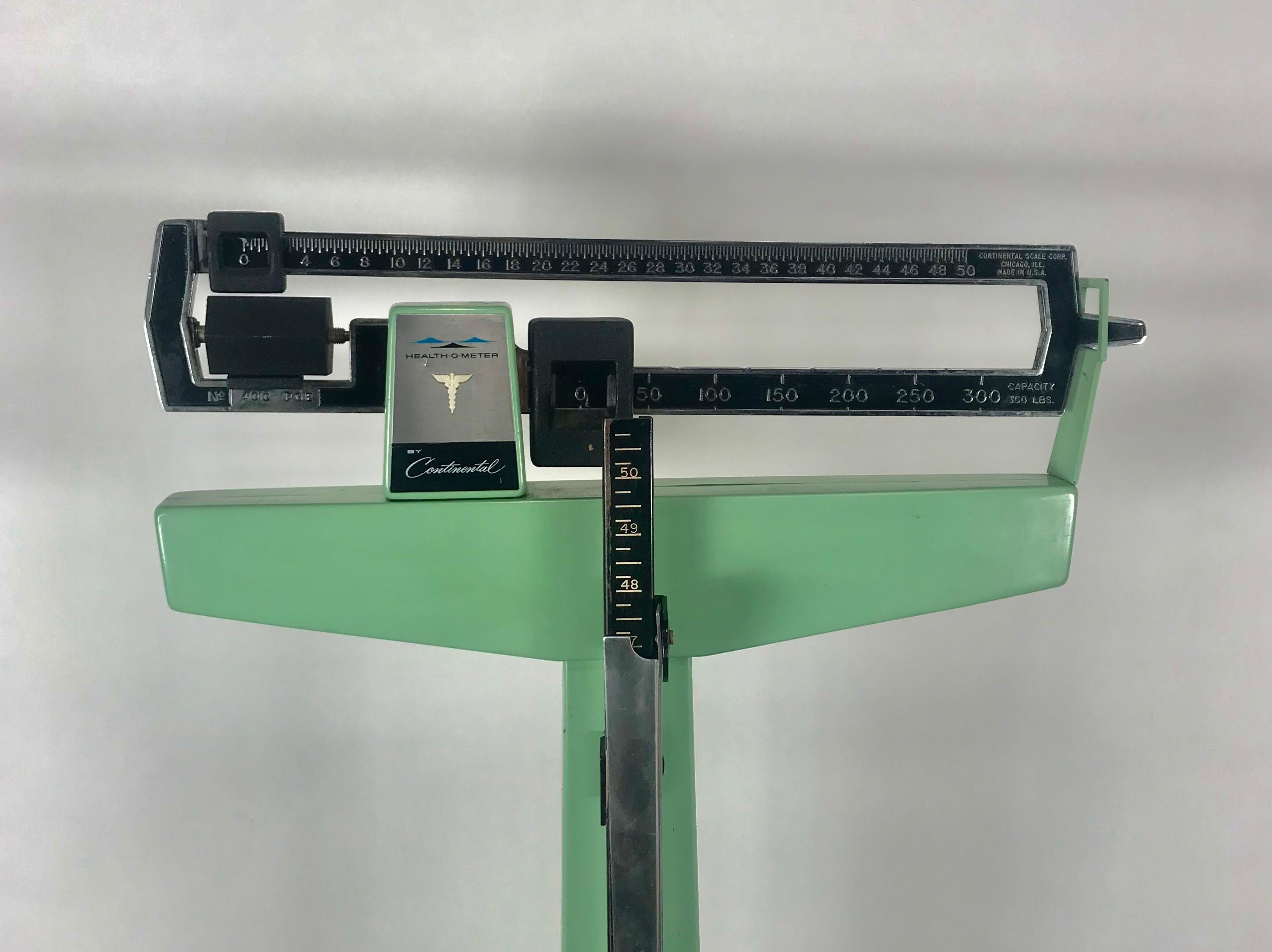 Mid-Century Modern cast iron medical floor scale by continental, health-o-meter. Amazing original condition. Classic 1950s mint green, in perfect working condition, complete with adjustable height.