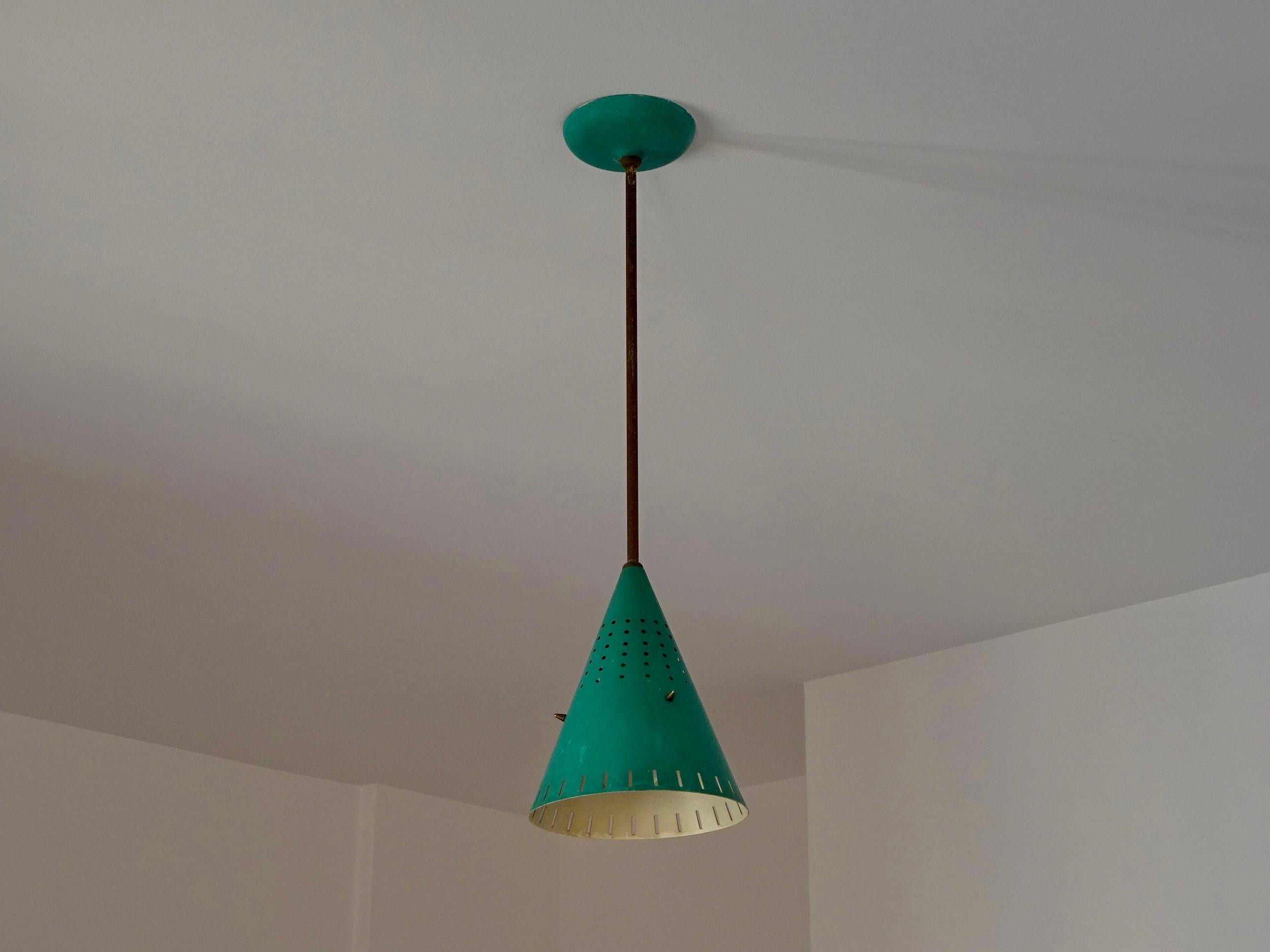 Ceiling light with conical shade, made of green aluminum, the stem and the rest of the details are made of brass. The shade has several perforations that reflect the light on the ceiling creating a special atmosphere.