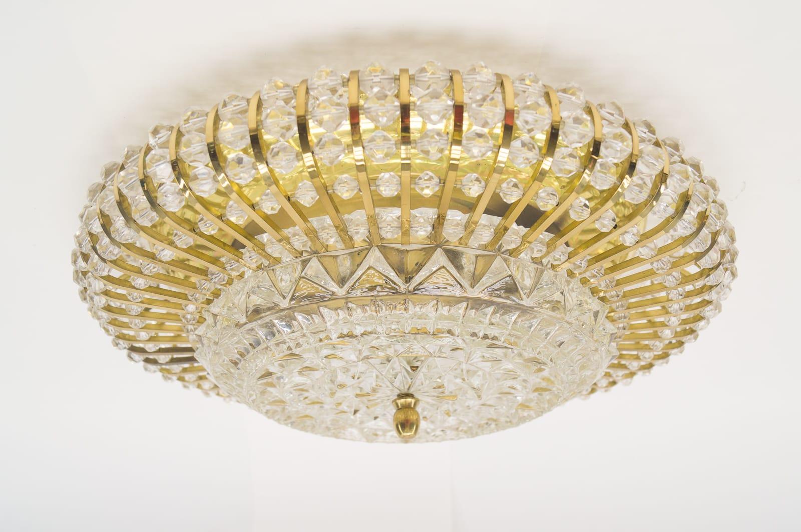 Mid-Century Modern ceiling lamp with glass stones and brass frame. 

Very high quality and in very good vintage condition.

All the stones at the outside and the glass in the middle are made of real glass. 

All stones complete and undamaged.