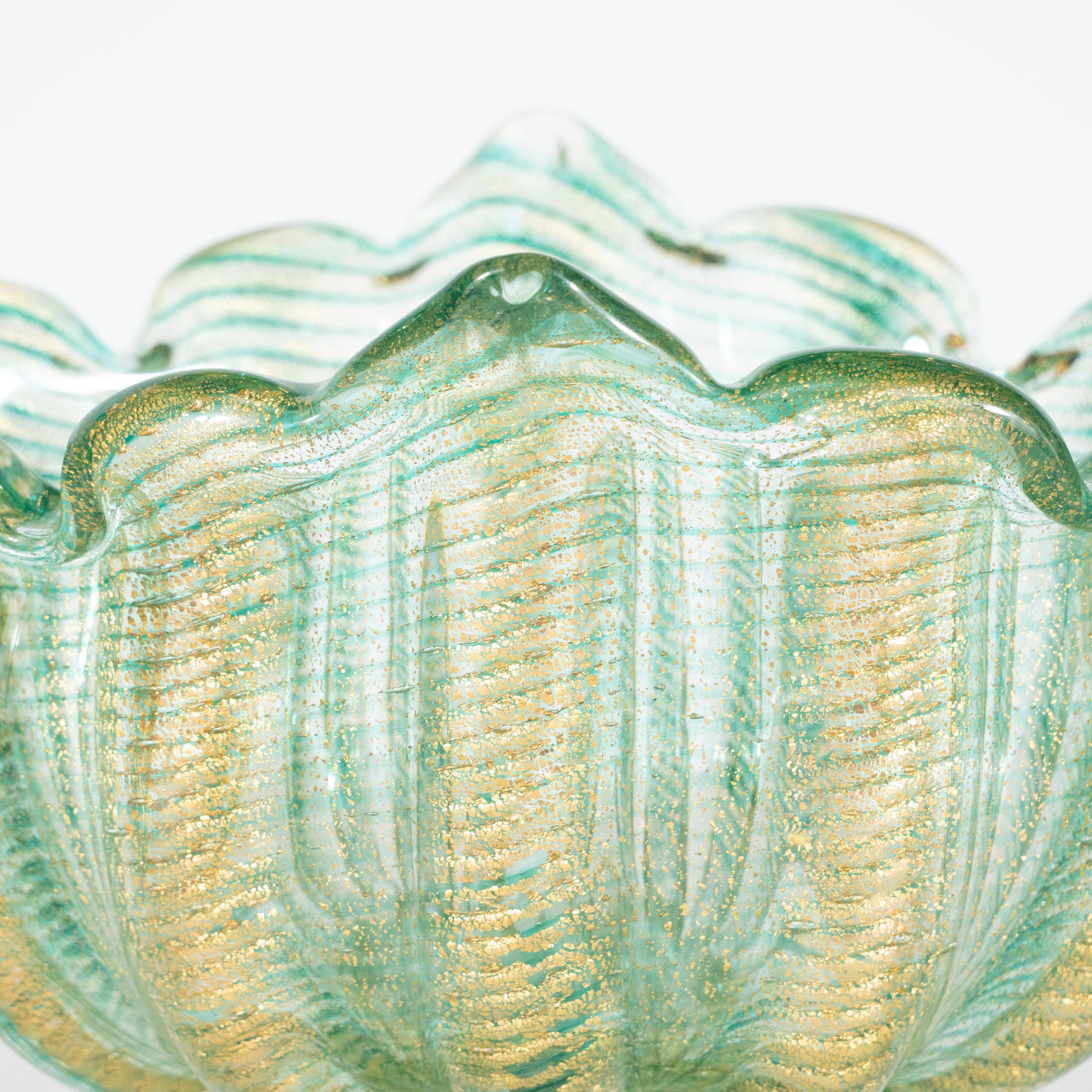 This beautiful celadon and 24-karat gold fleck Murano glass pedestal vase was hand-crafted by Barovier & Toso's celebrated artisans, circa 1950. The vase resembles an abstracted bloom and sits on a ribbed base with scalloped edges. Two rosettes are