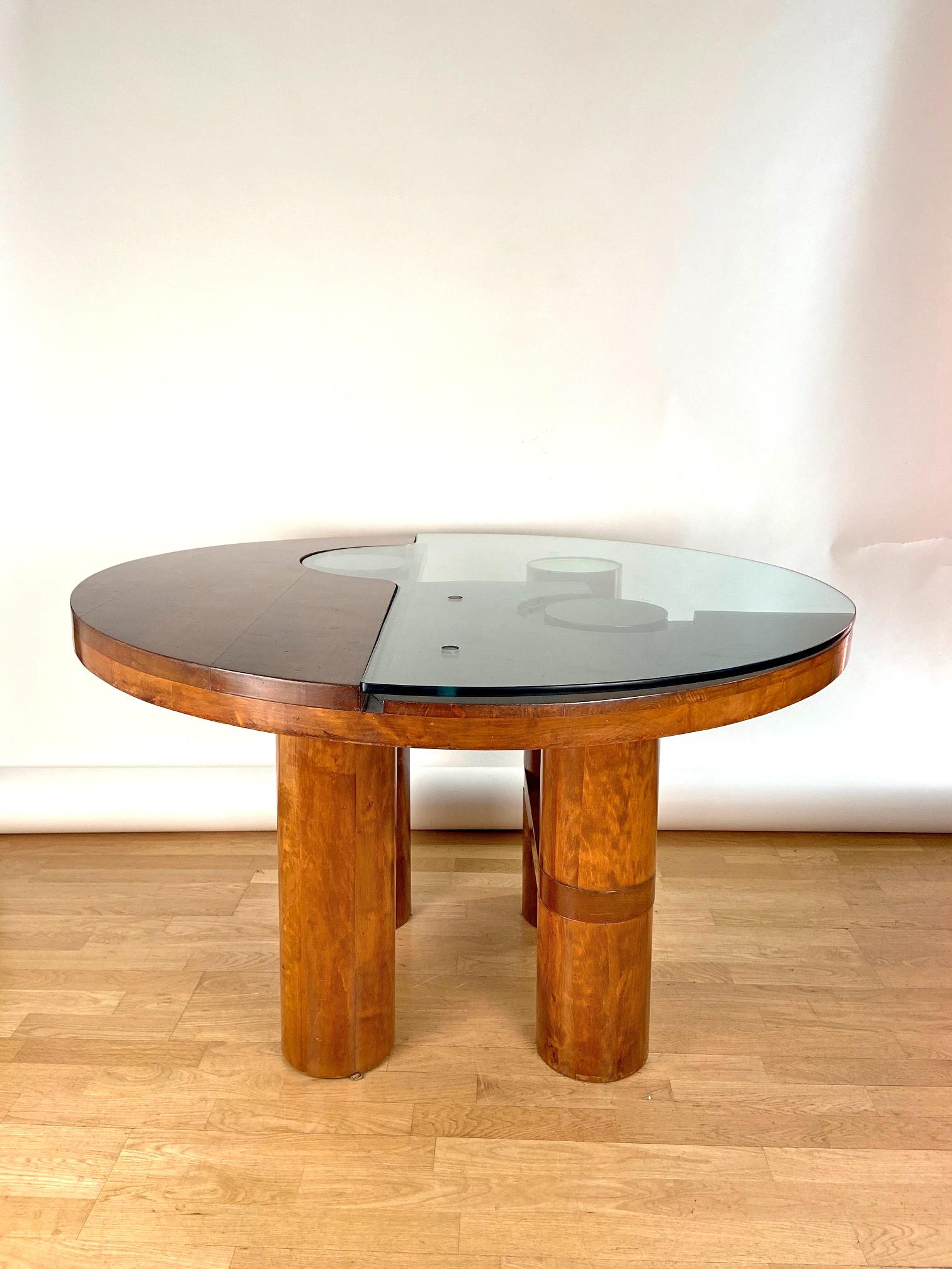 An sculptural and unique dining/center hall table. Designed by Nerone and Patuzzi and edited by NP2 Group . Walnut structure and glass and wooden top on four wooden legs ended by wooden and brass finishings, circa 1970.Excellent condition. A