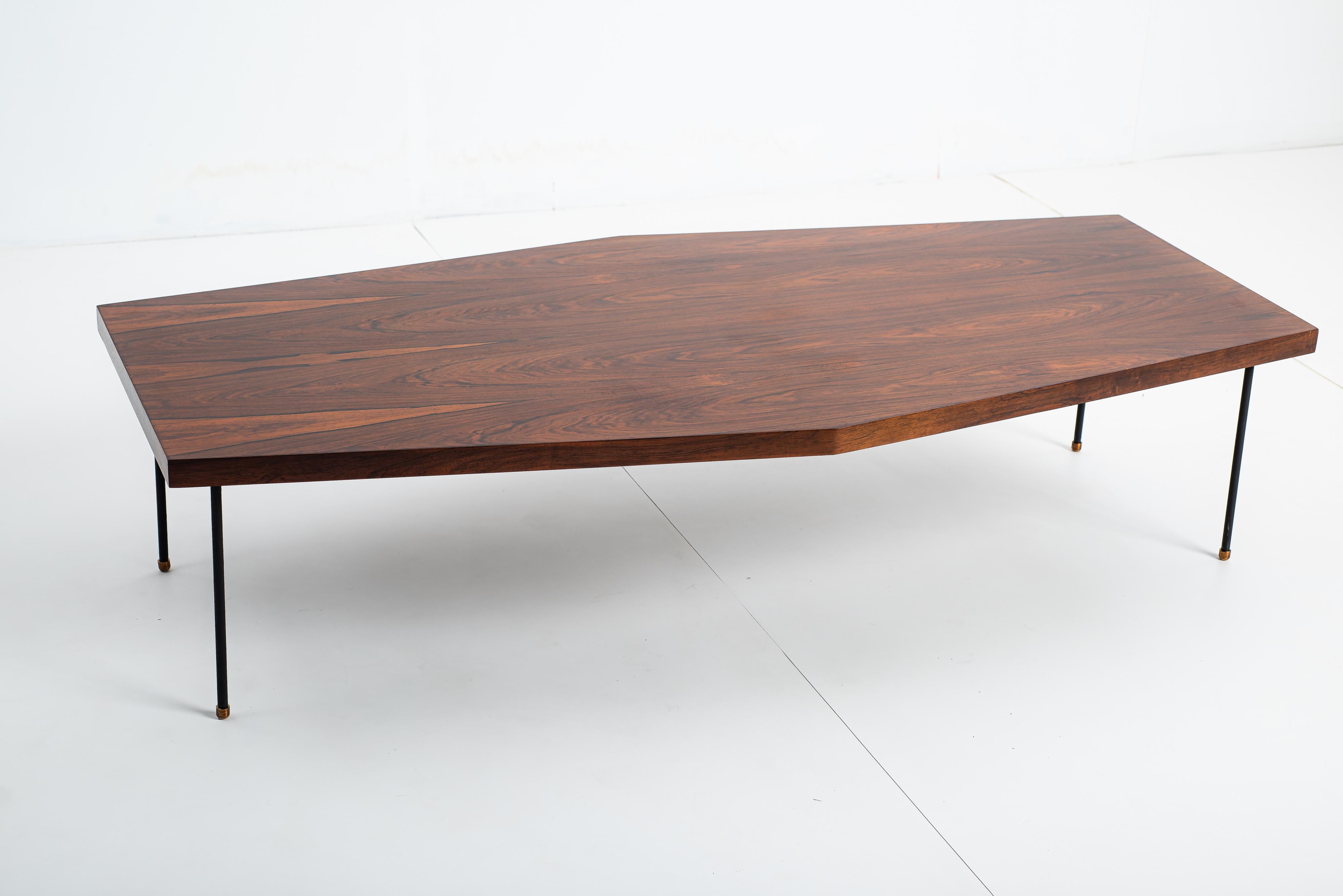 Mid-Century Modern Center Table by Brazilian Designer, 1960s

Coffee table from the 1960s, by an unattributed Brazilian designer.
It has a wooden top and is supported by slender iron legs with brass tips, adding a touch of elegance and lightness to