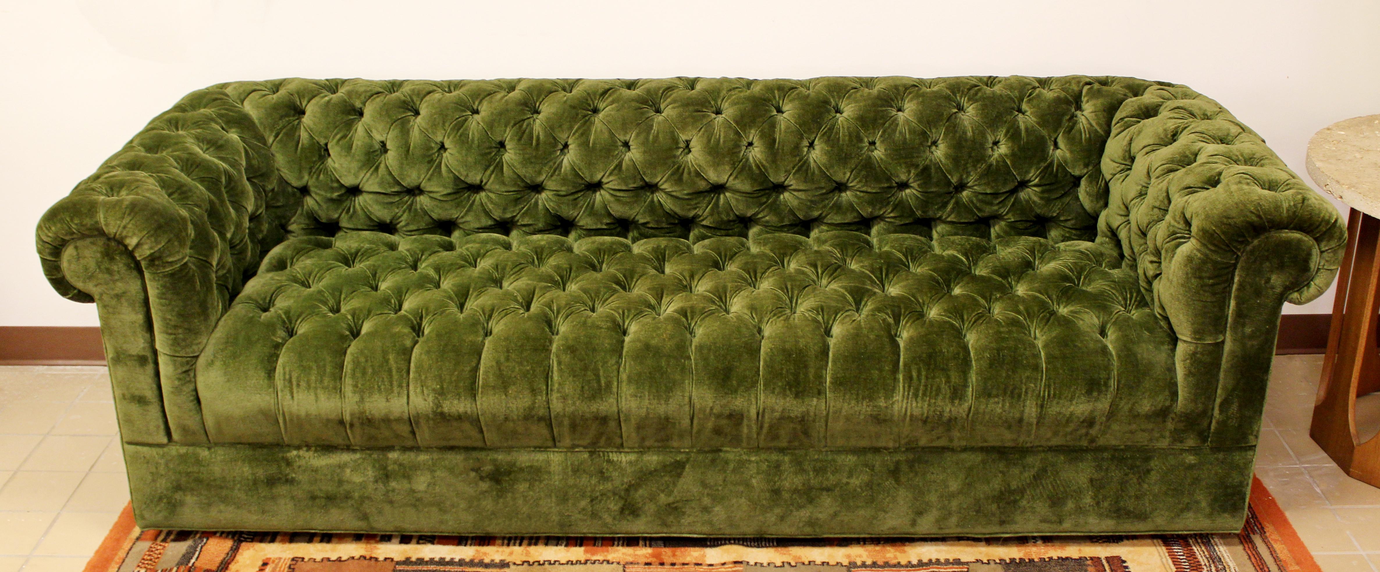 For your consideration is a fabulous, green, tufted sofa on casters, by Century, in the style of Milo Baughman, circa the 1960s. In excellent condition. The dimensions are 87