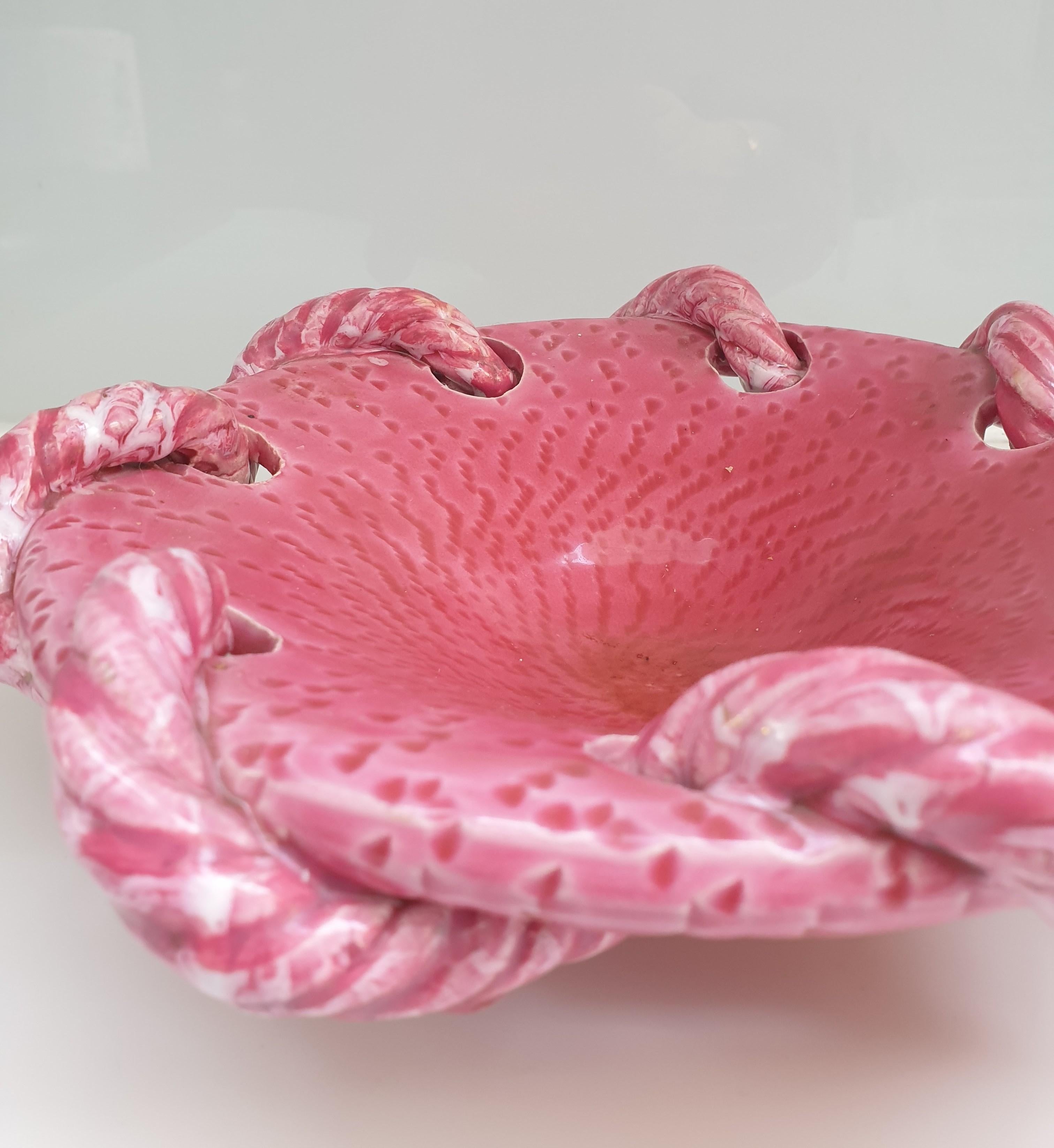 Unusual glazed vintage ceramic bowl created in the famous potteries of Vallauris in the South of France. This rope design is a classic motif made famous in this area but the colour, a beautiful rose pink, is quite rare. These potteries were at their