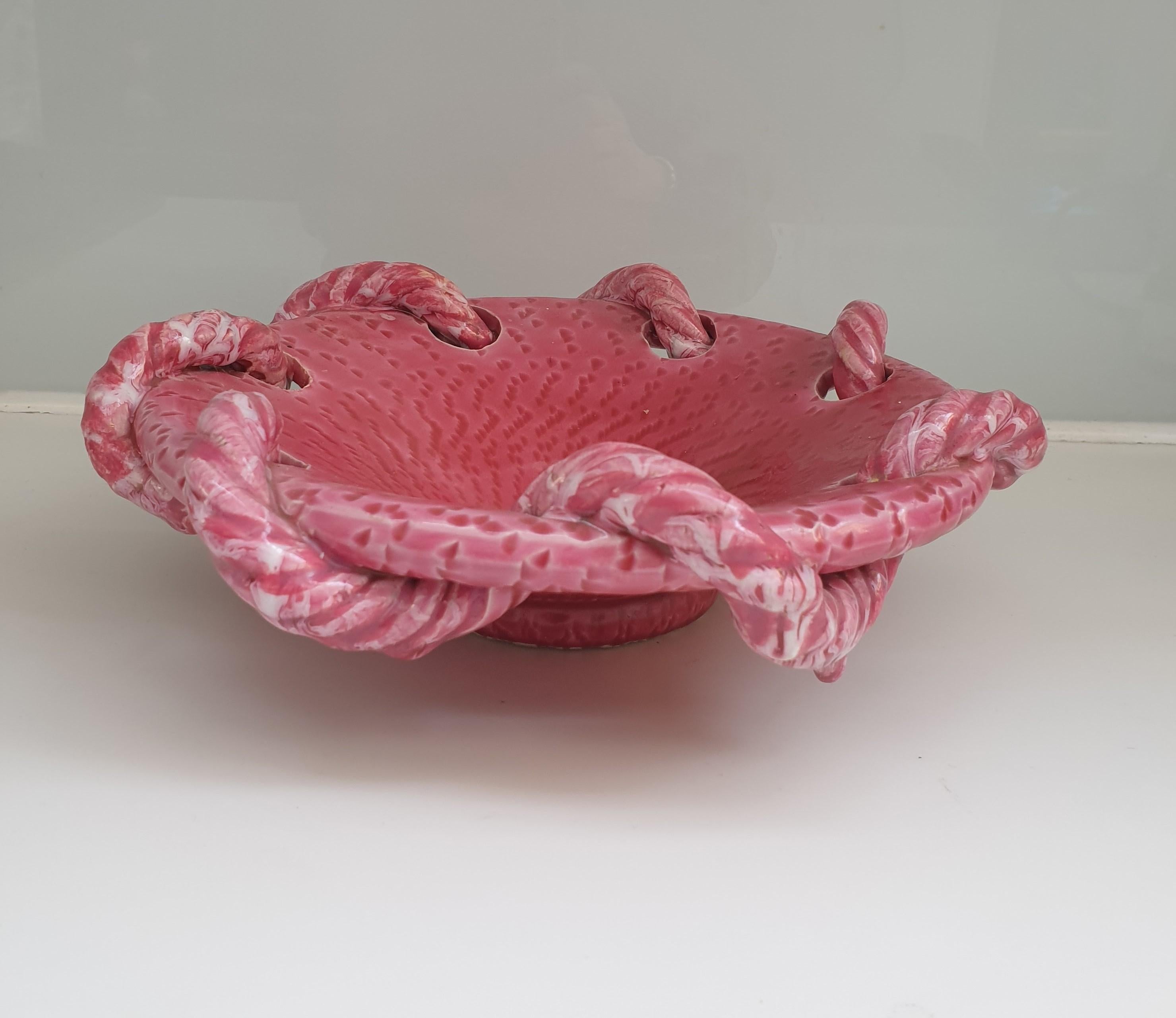 Unusual glazed vintage ceramic bowl created in the famous potteries of Vallauris in the South of France. This rope design is a classic motif made famous in this area but the colour, a beautiful rose pink, is quite rare. These potteries were at their