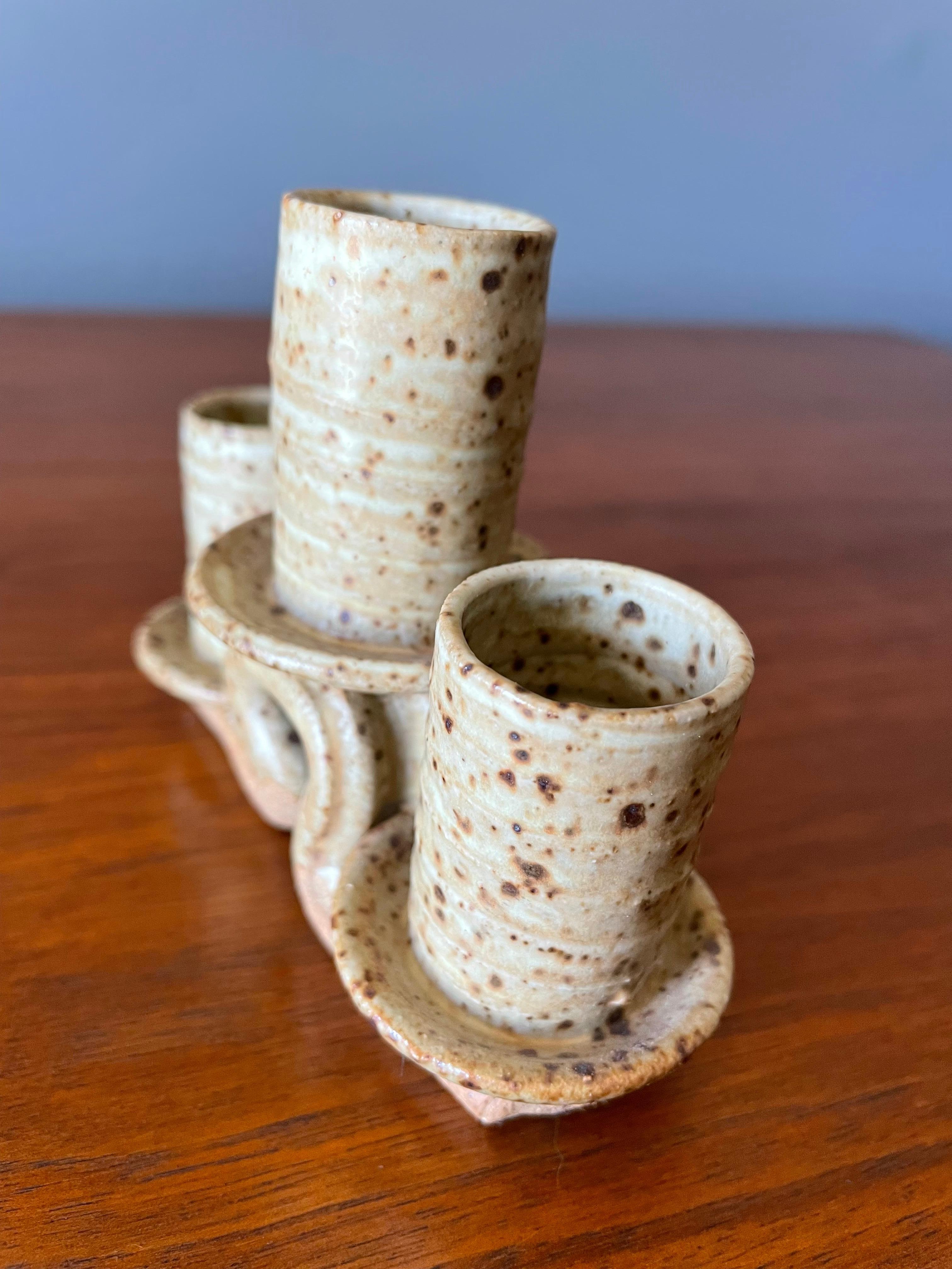 Ceramic candelabra in a speckled, neutral glaze. Holds 3 standard size size candles.